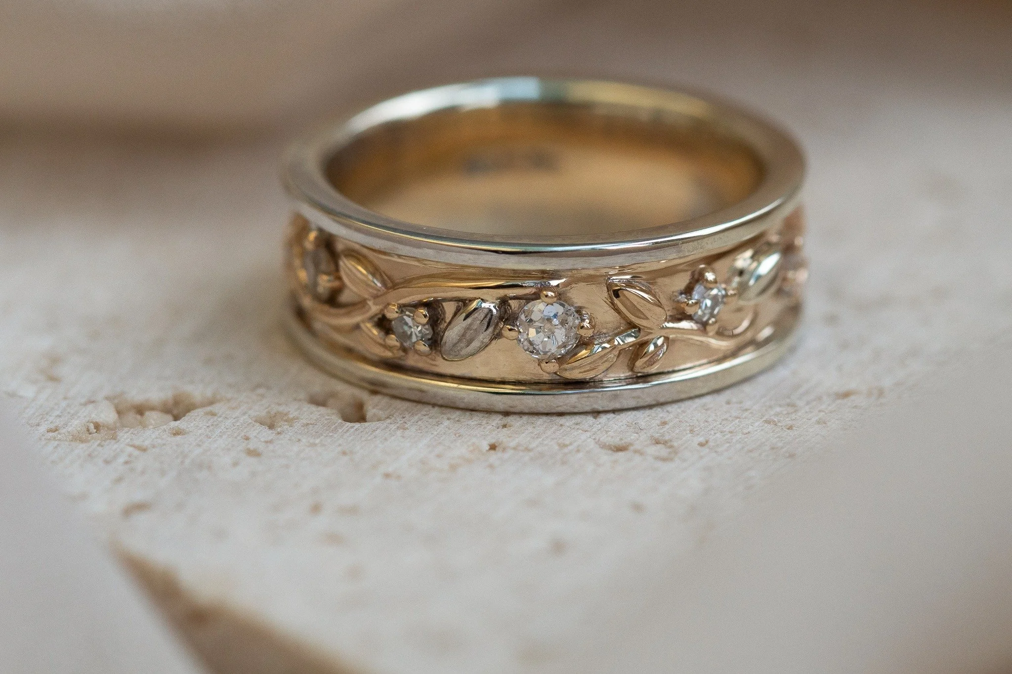 When Chris sat down with Karen and me, she had no real idea what she wanted for her wedding ring. Not being someone who wears much jewellery, her first instinct was something simple and wide, incorporating the diamonds from two sentimental rings she 