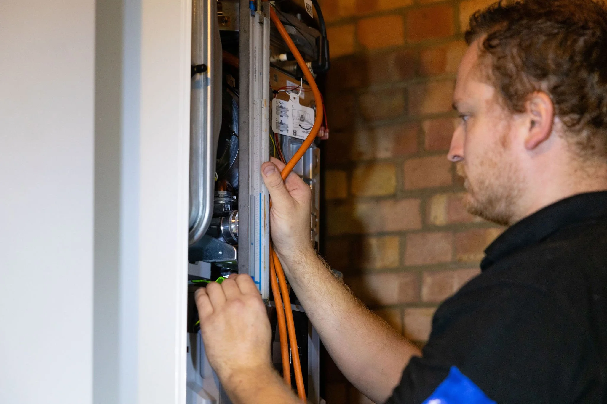Gas Engineer checking boiler compliance