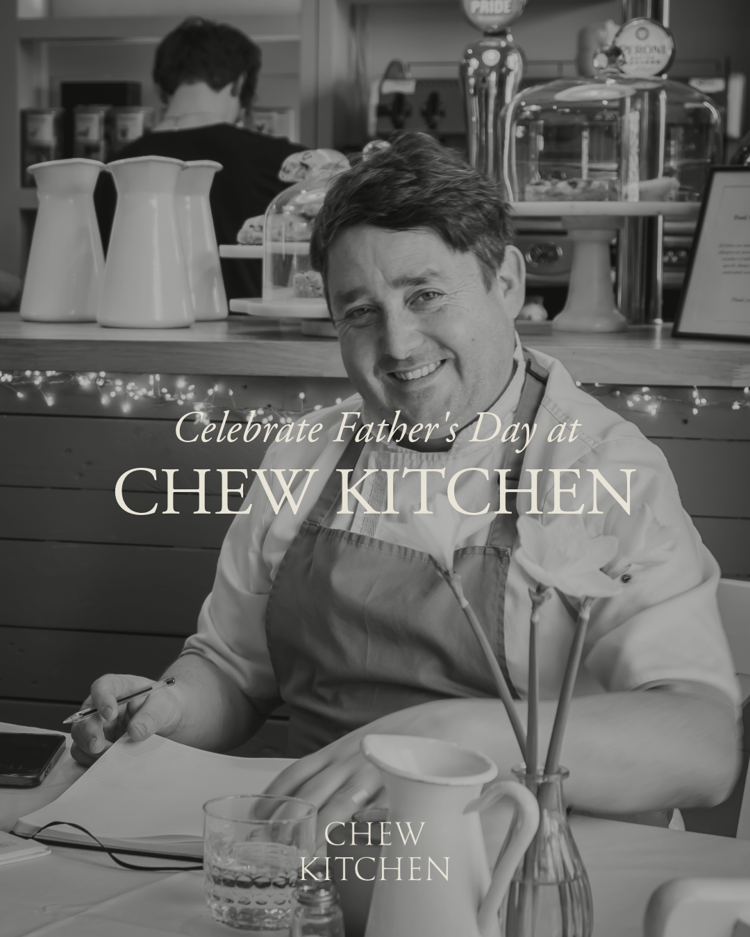 Black and white image of man at table