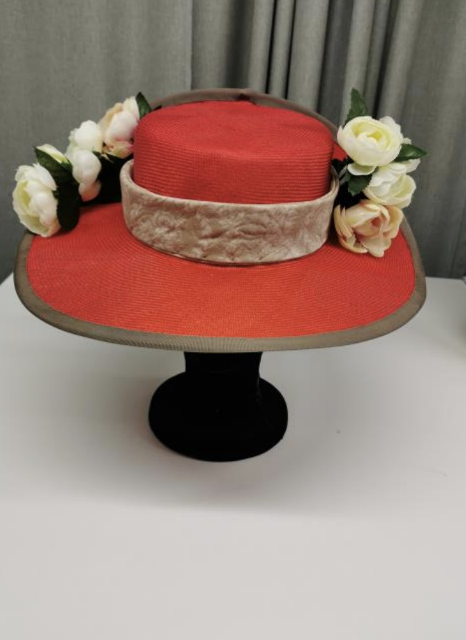 Blocked red straw hat, trimmed in brown and beige fabric and white peonies.