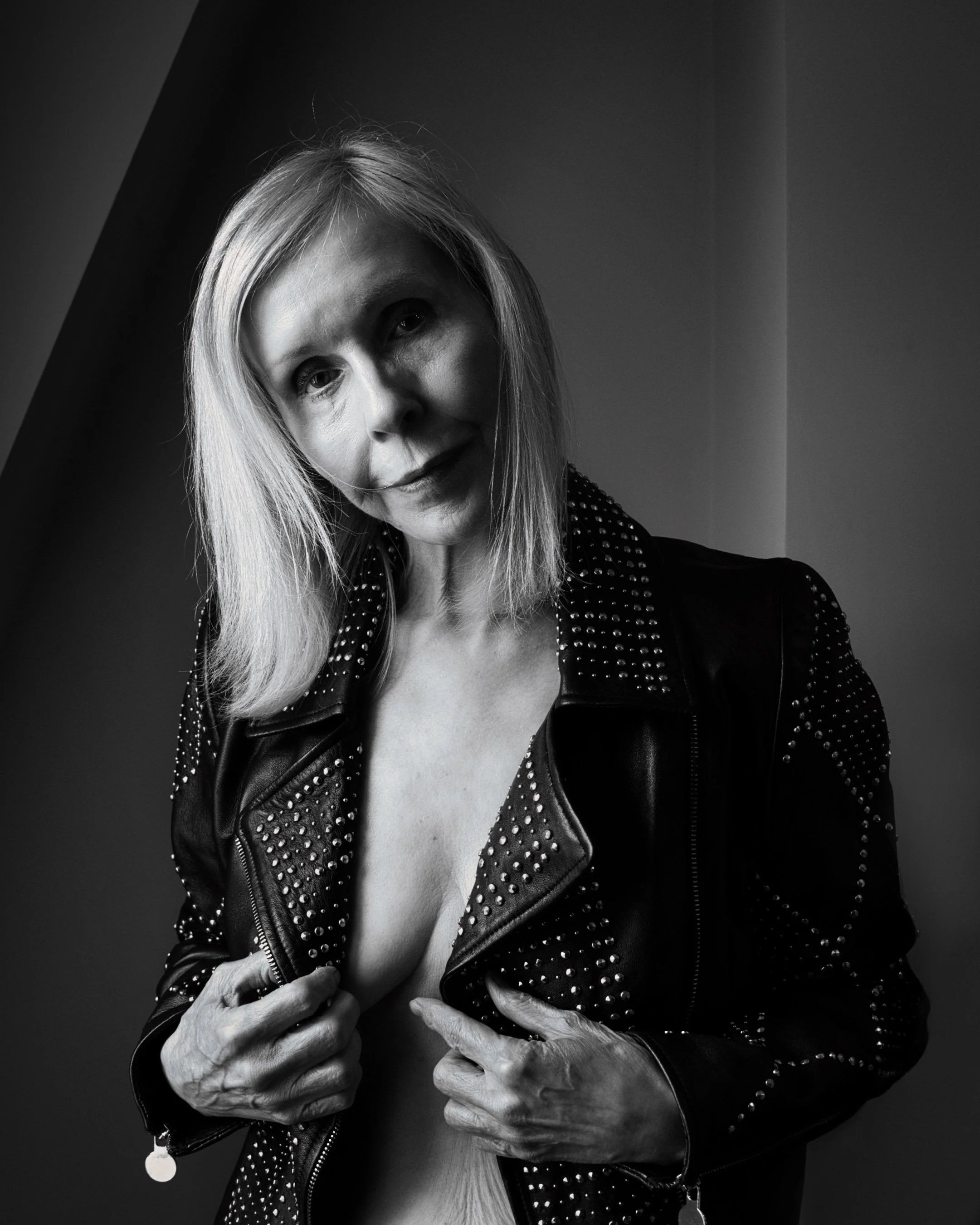 Artistic nude portrait of a blonde woman in dramatic side light