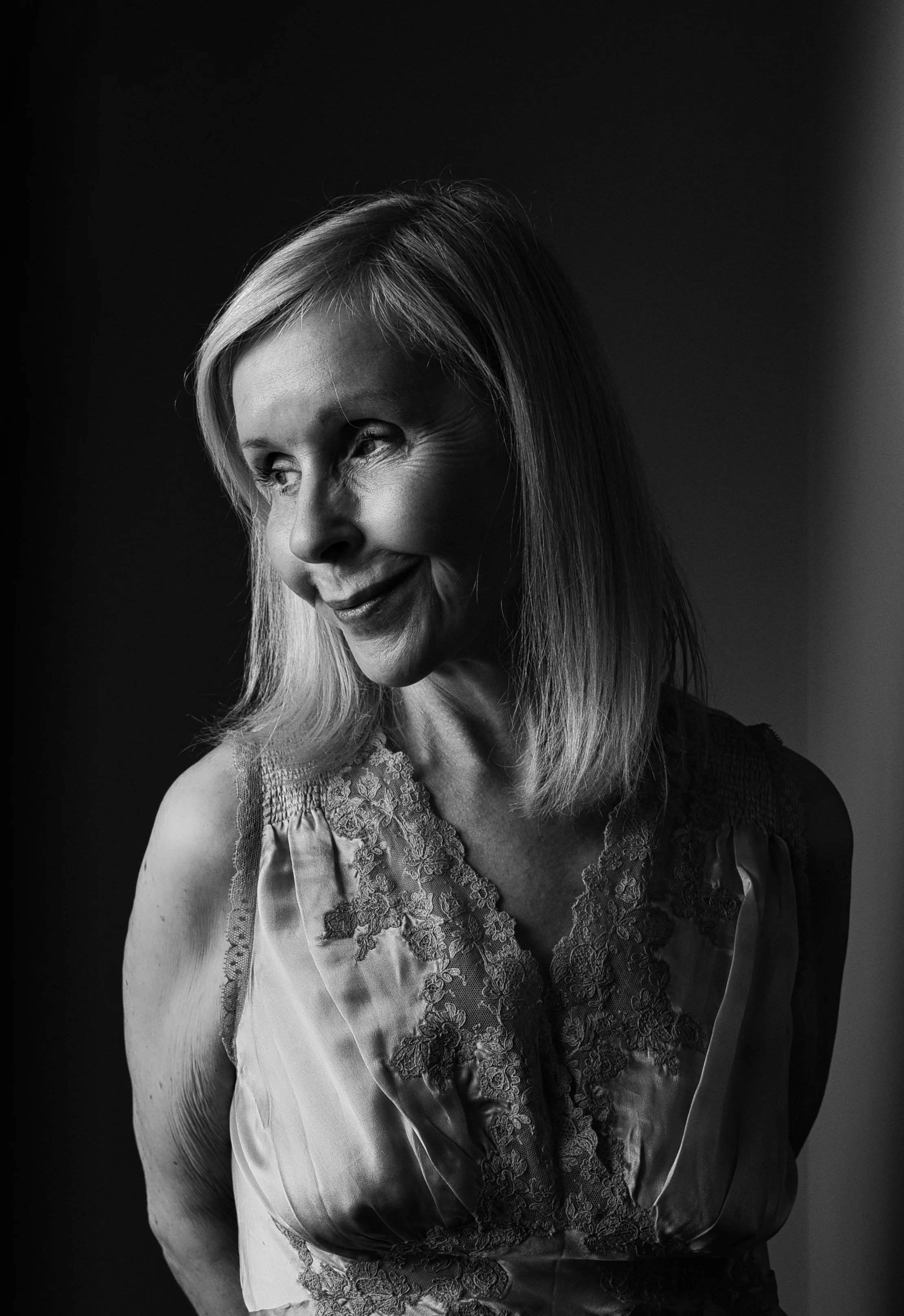 Black and white portrait of a blonde woman in soft window light