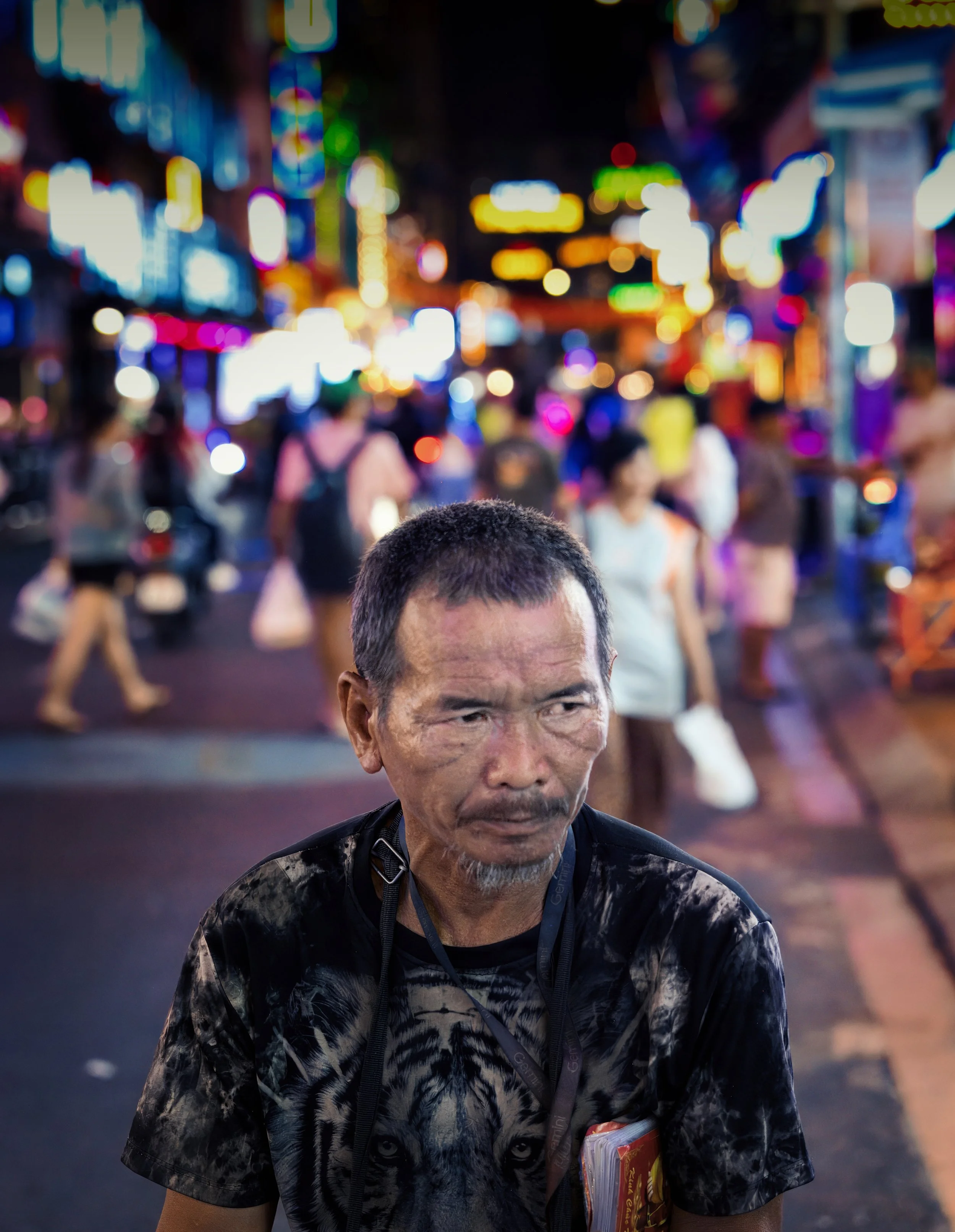 Portrait of a man on a neon-lit street in Ho Chi Minh City at night