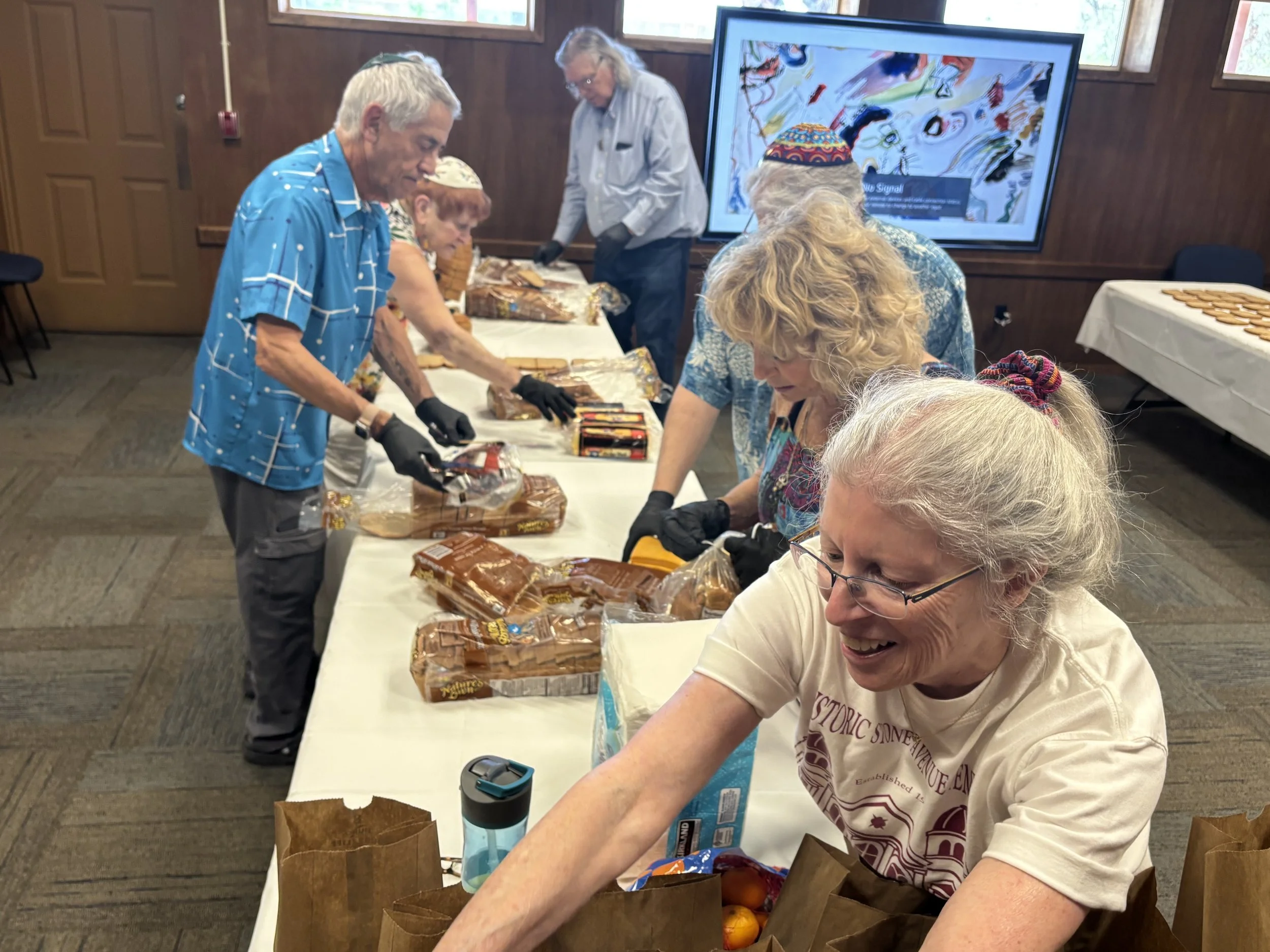 All smiles while making lunches for Primavera Men's Shelter!