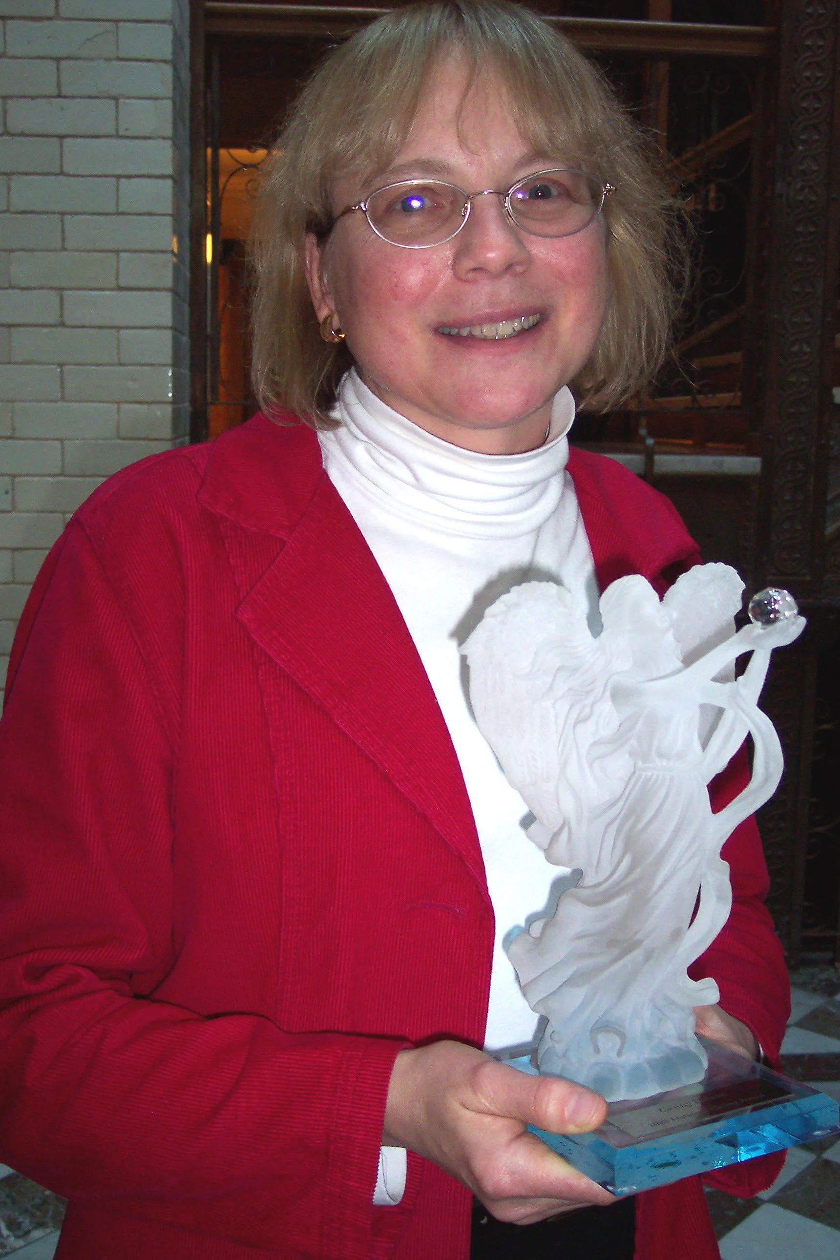 Genny holds Natl Caring Award.jpg