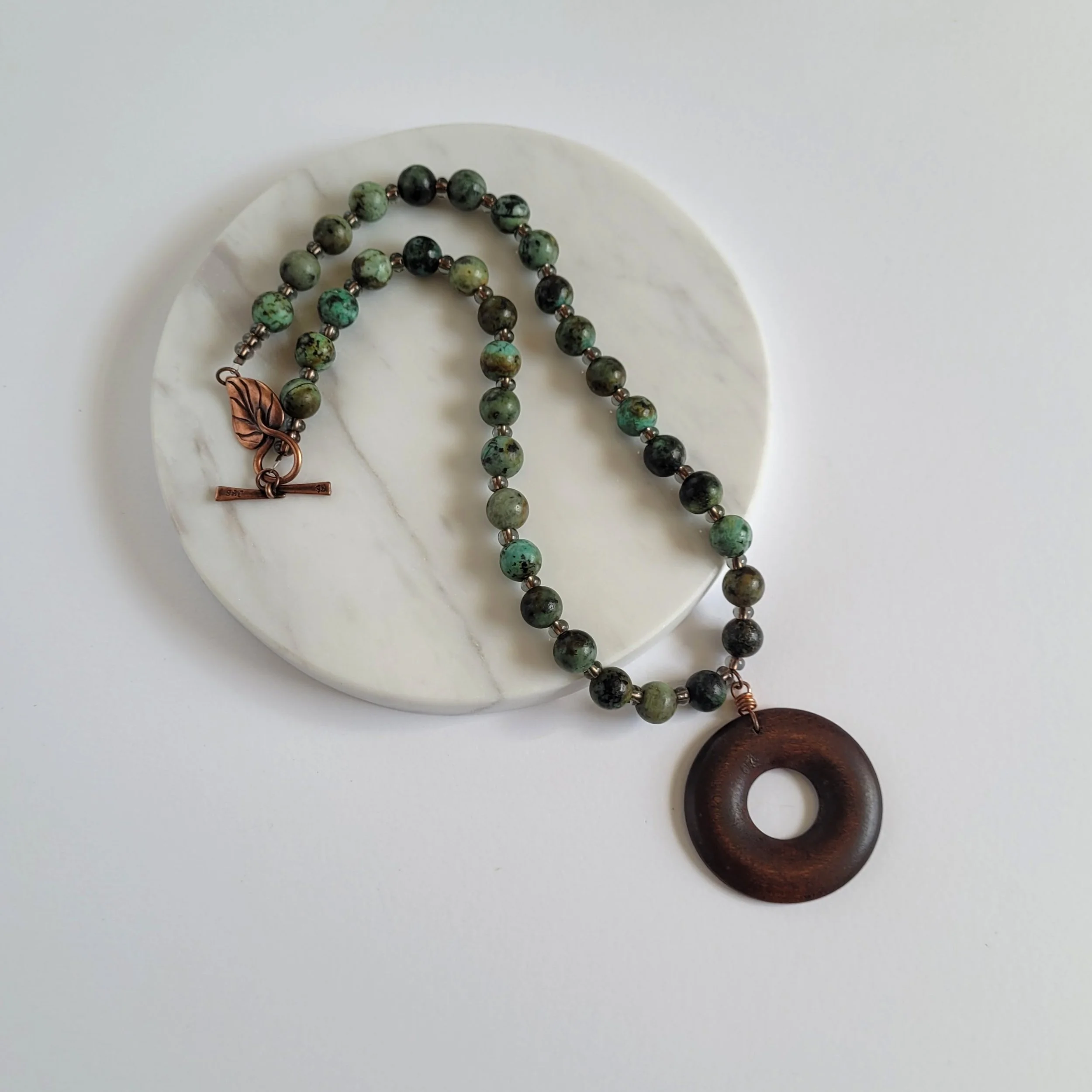 African turquoise jasper necklace with wooden donut pendant with hand wrapped copper bail