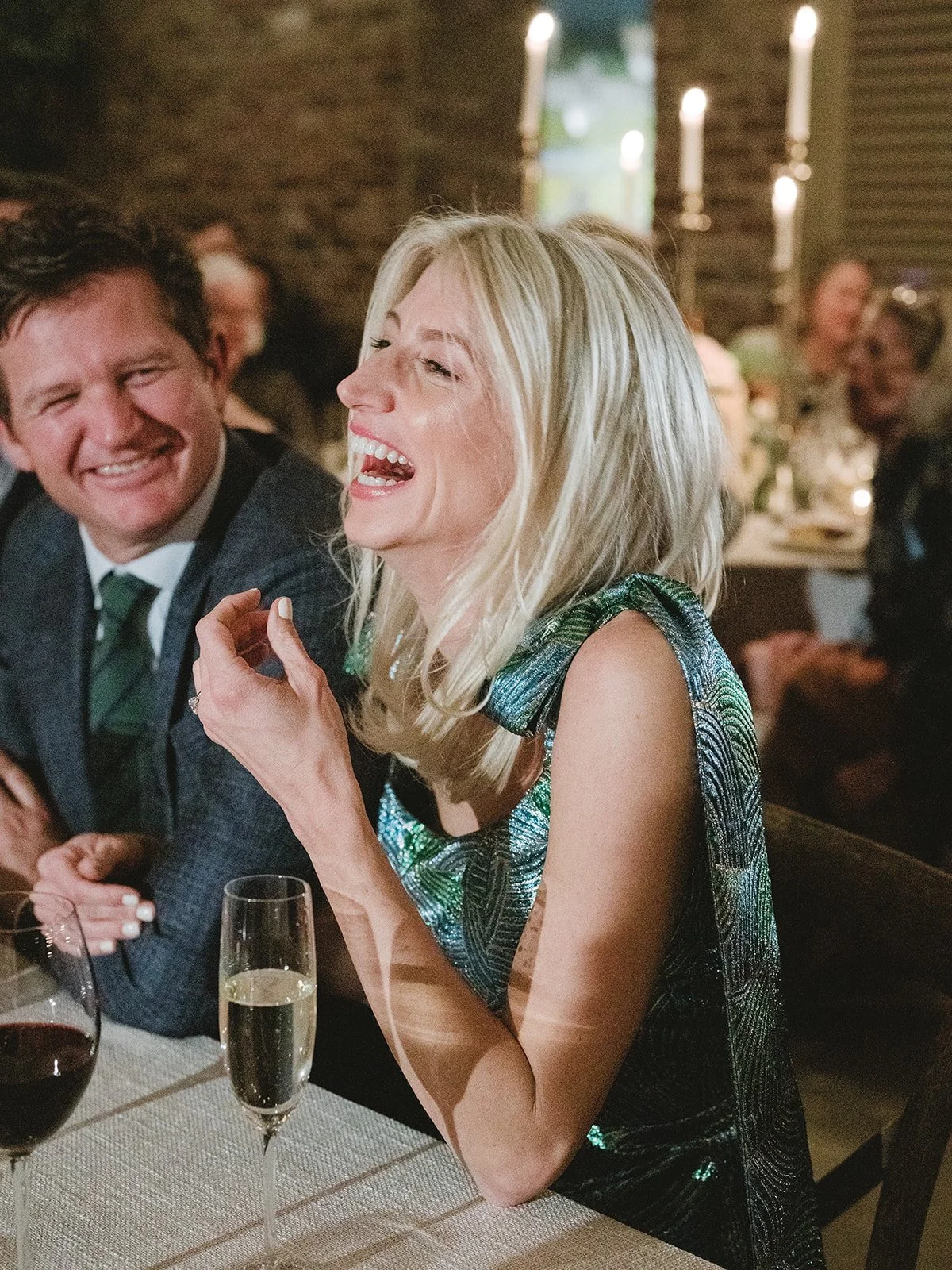 Bride laughing at rehearsal dinner
