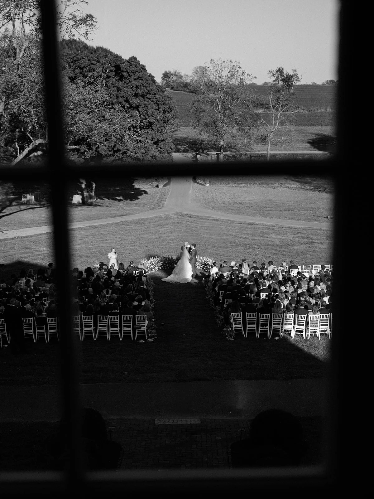 Window view overlooking beautiful horse farm wedding