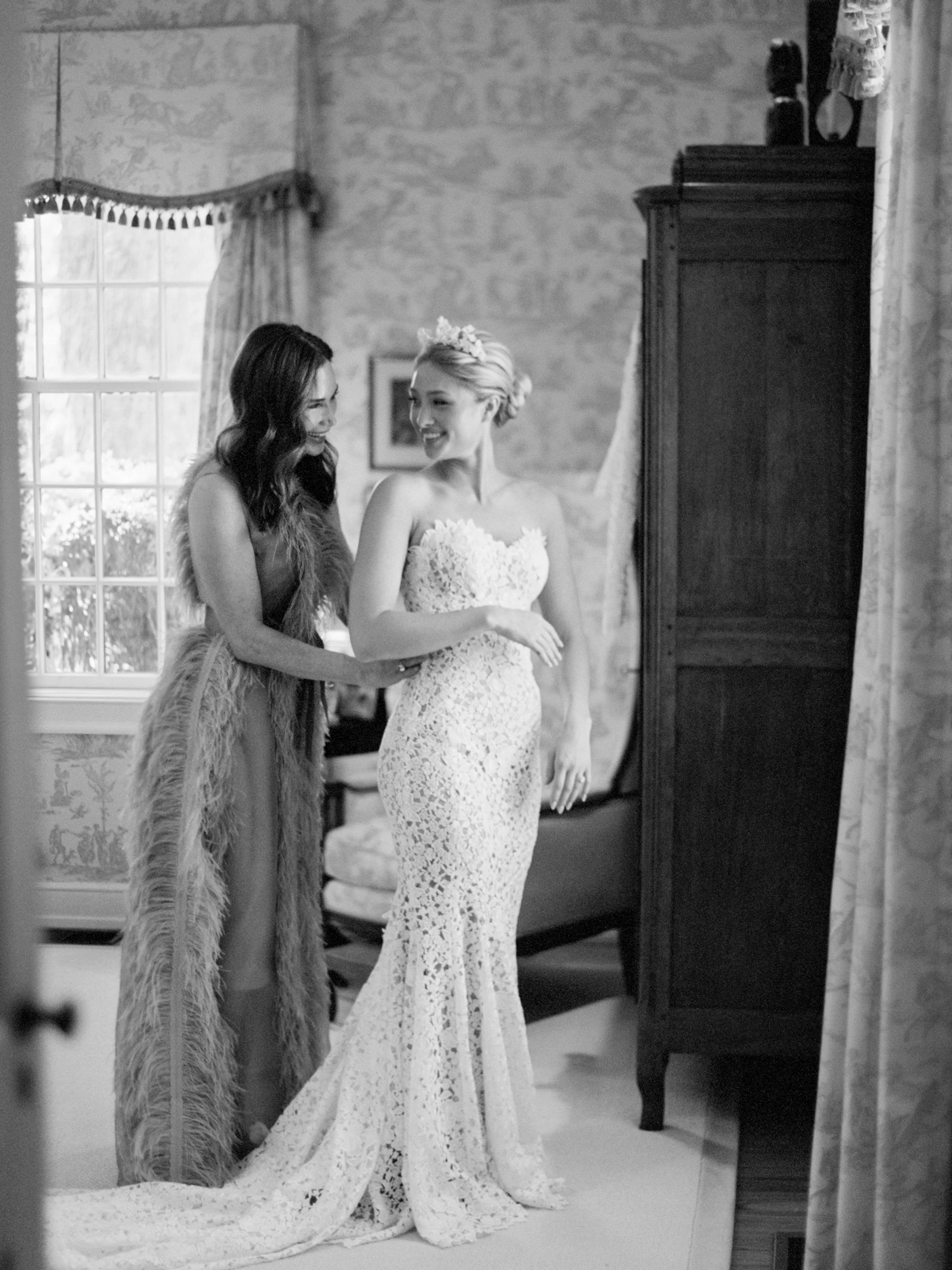 Bride getting on her Monique Lhuillier wedding dress with mom in familys paris ky estate