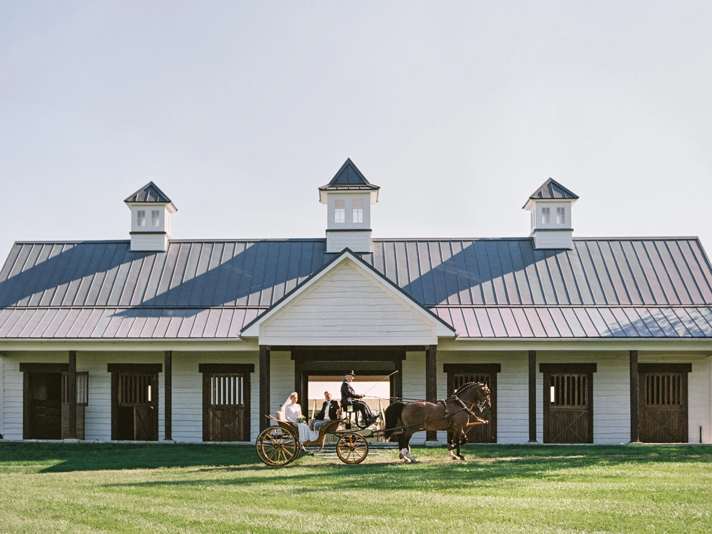 Bride and father of bride escorted to wedding ceremony on world class horse and carraige