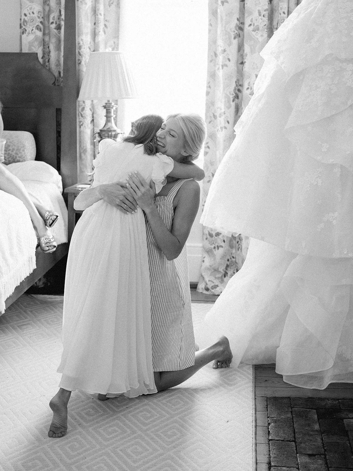Bride hugging flower girl at paris ky wedding estate while getting ready