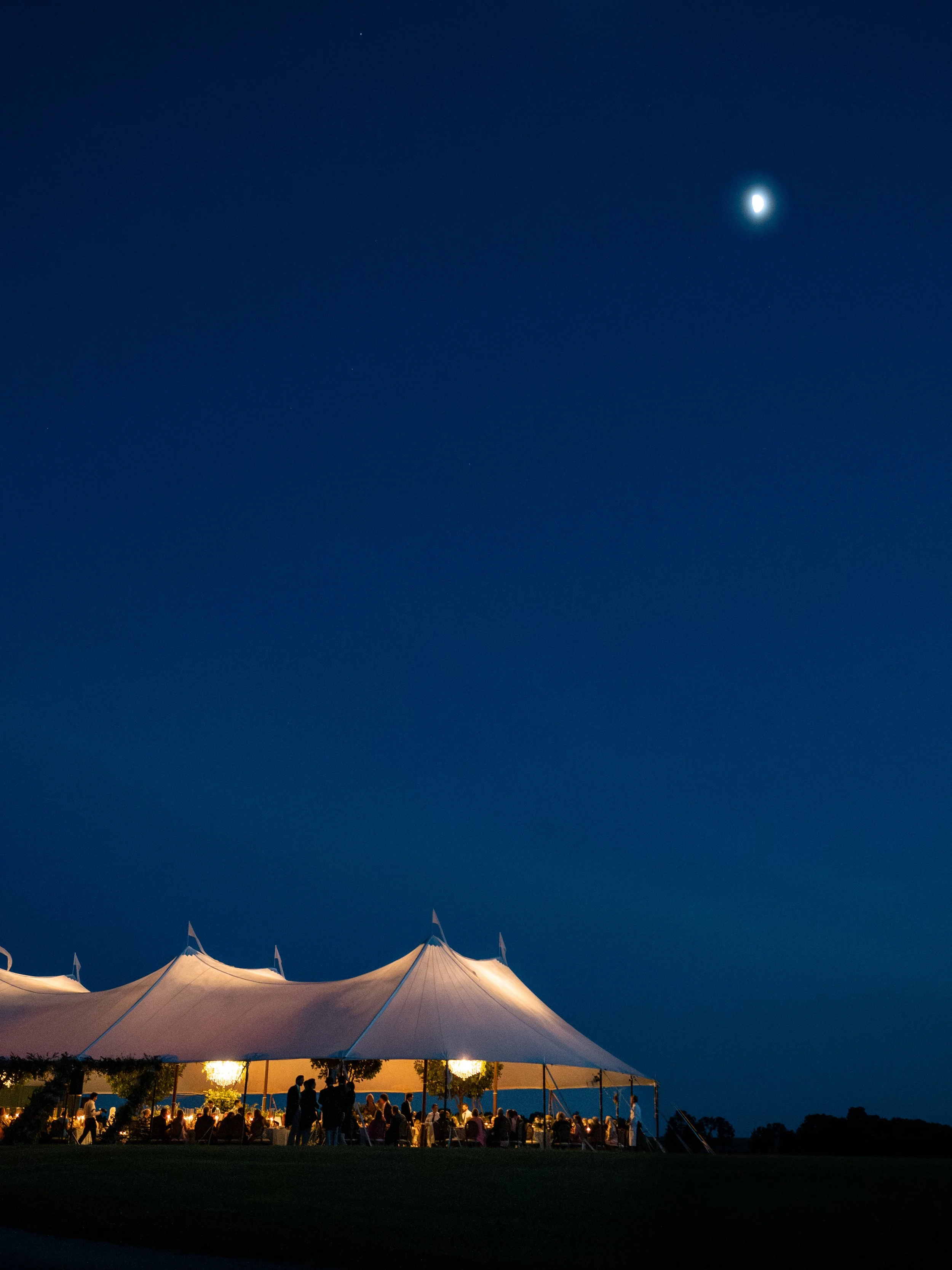 Sailcloth tent glowing at night on Augustus Hill Farm wedding in paris kentucky
