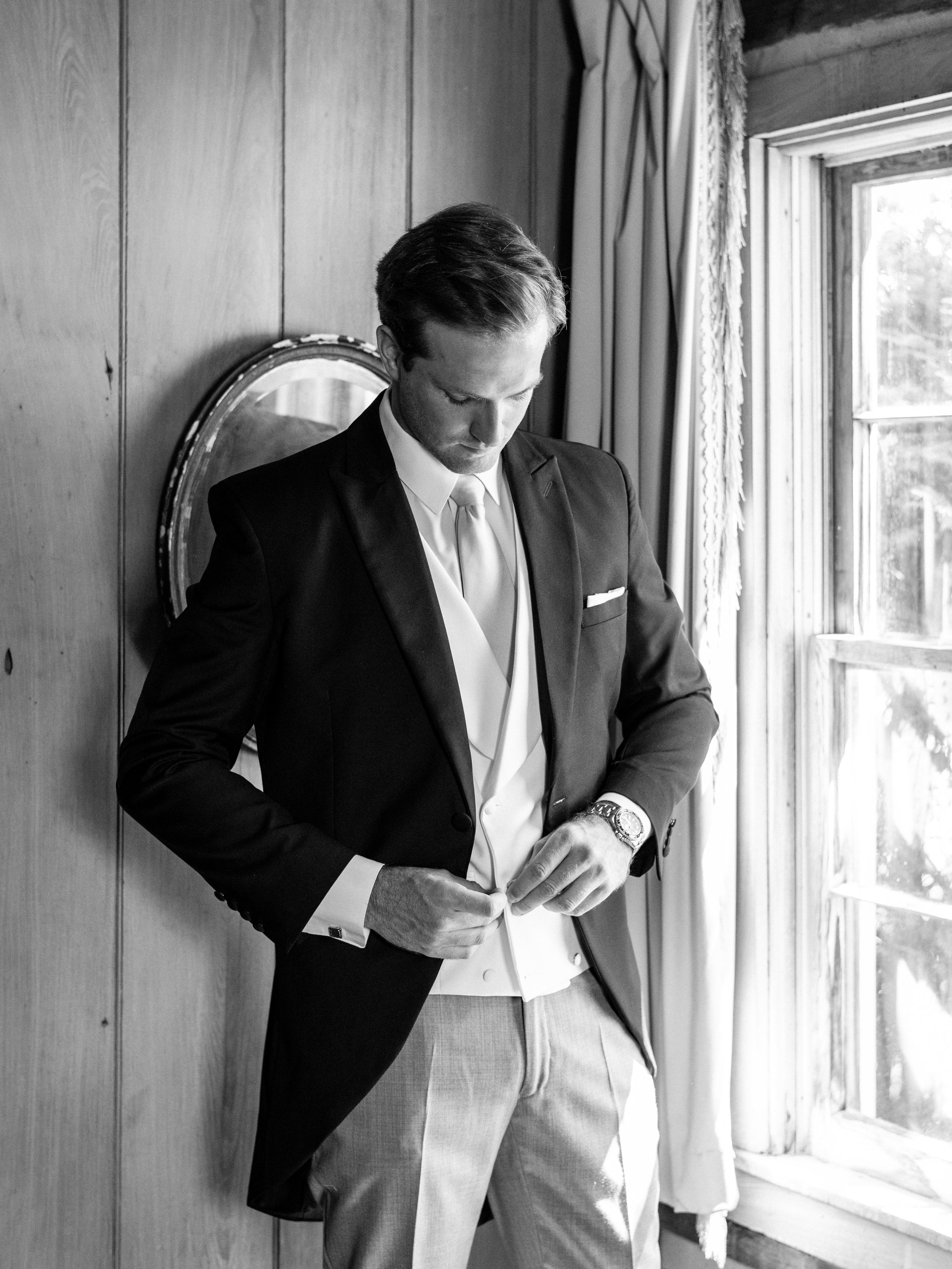 groom getting ready in formal attire on his wedding day in paris kentucky