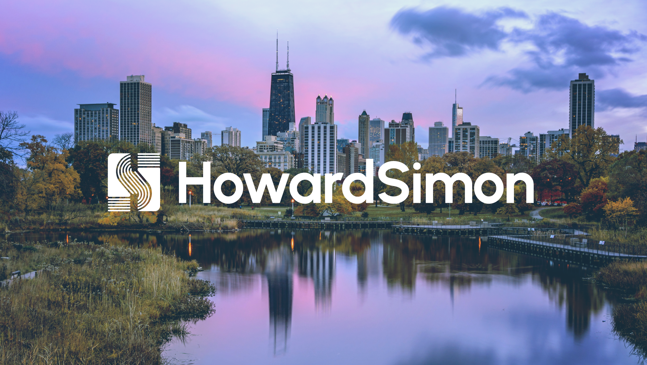 Chicago skyline with city buildings, trees, and reflecting water during sunset, with the overlay text 'HowardSimon'