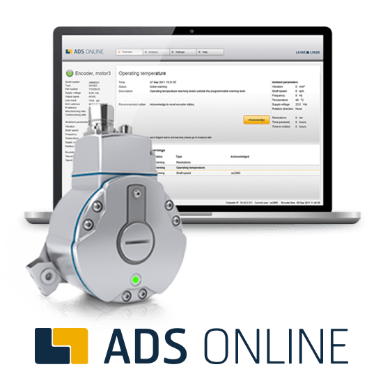 A laptop displaying an industrial monitoring dashboard on the screen, with a gray device with multiple screws and a circular component in front of it, and the text "ADS ONLINE" at the bottom.