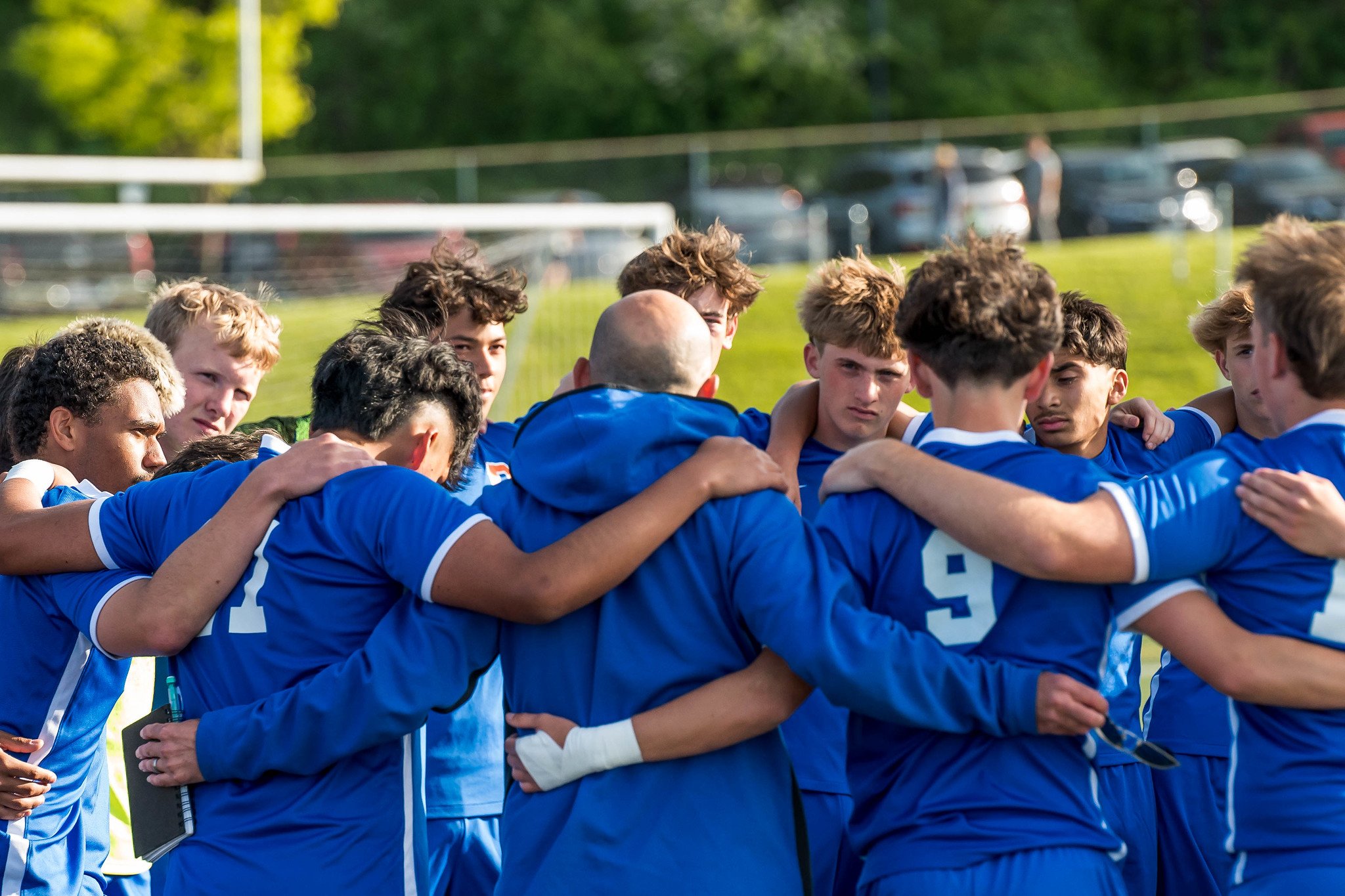 Huddle with coach Jake Roberts (center)