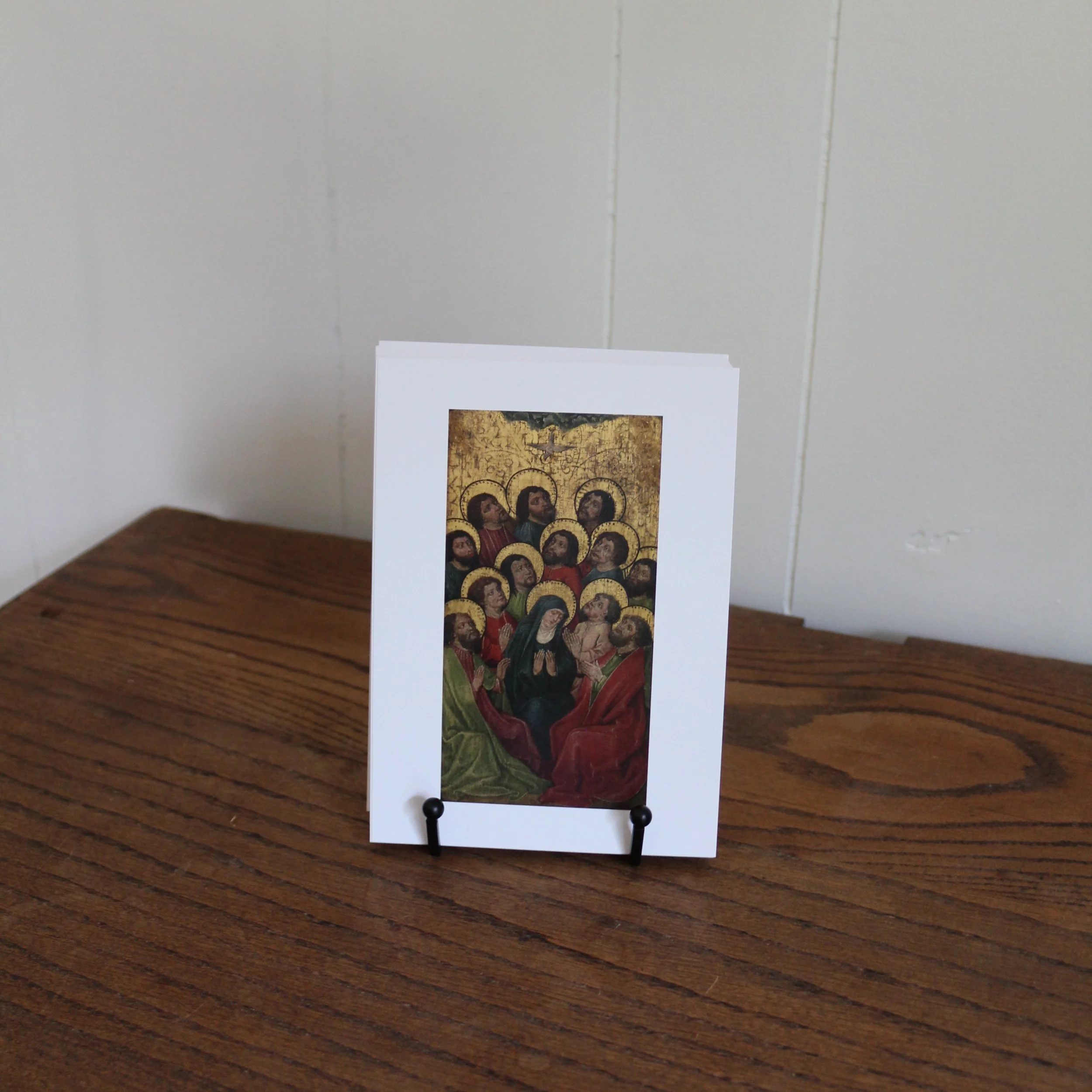 Catholic liturgical calendar cards displayed on a prayer card stand