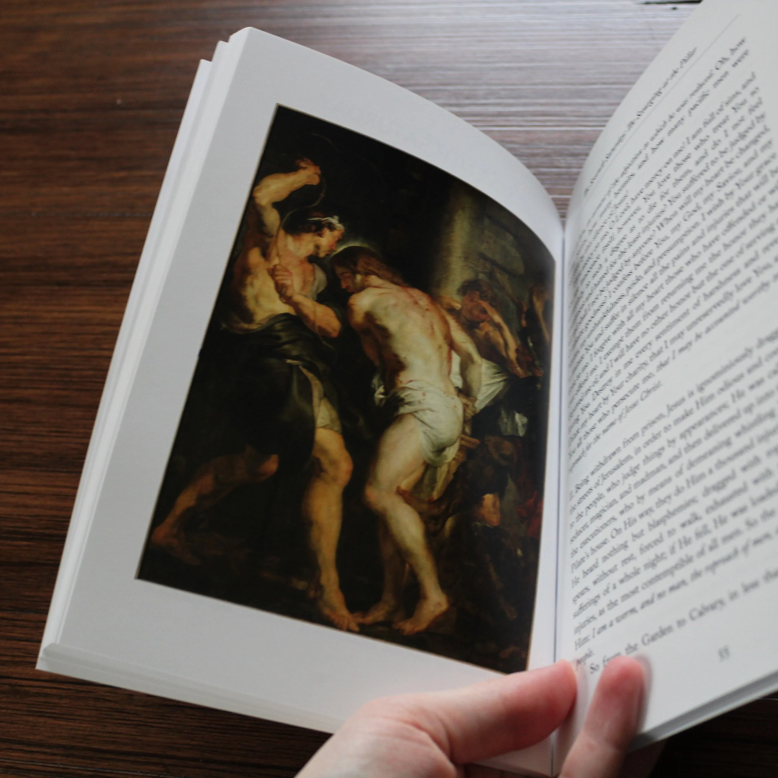 The Fifteen Saturdays book opened to the Scourging of Christ meditation and sacred painting