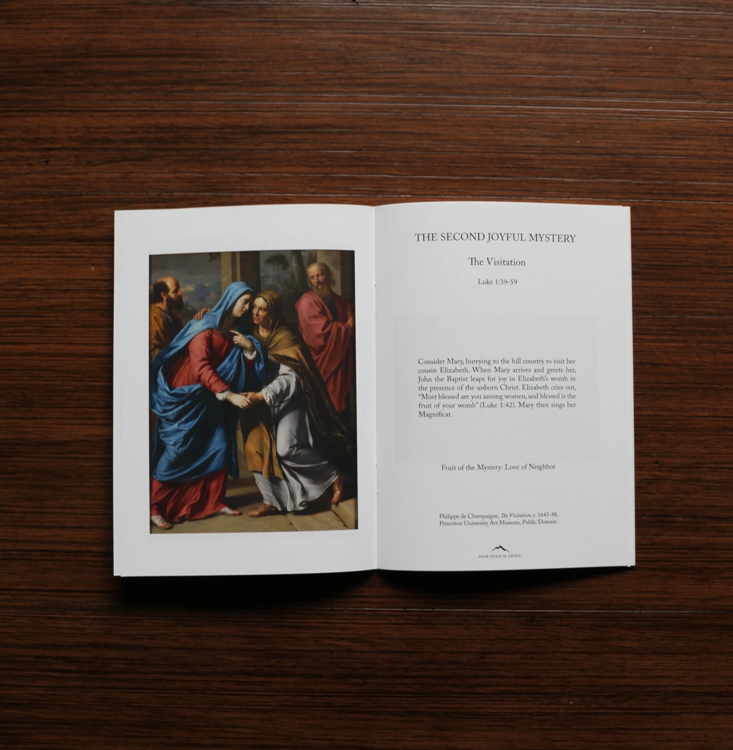 Catholic Rosary book open to Visitation Mystery with sacred art painting and meditation