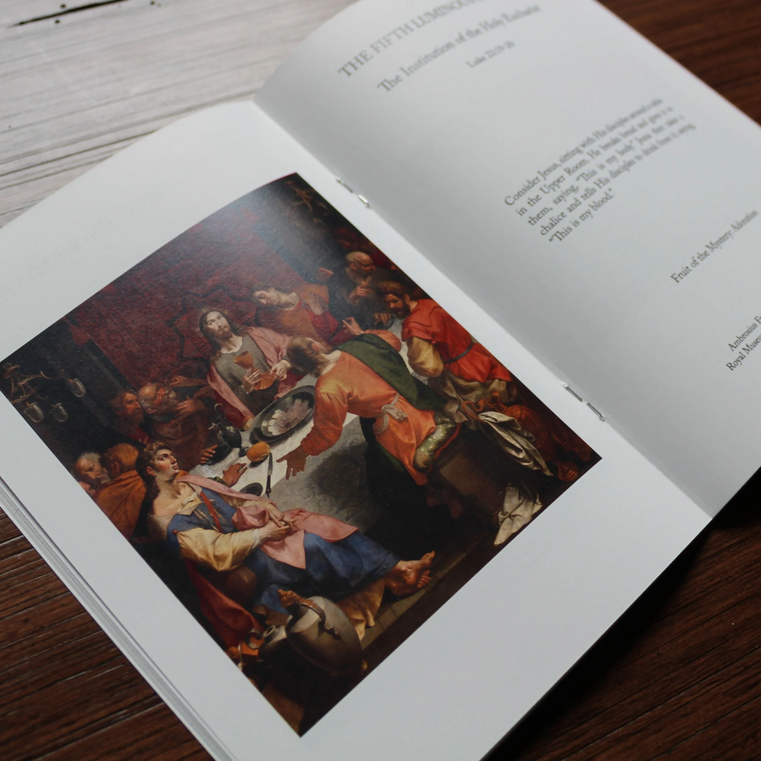 Rosary meditation book showing Last Supper sacred art with Luminous Mystery reflection on Eucharist