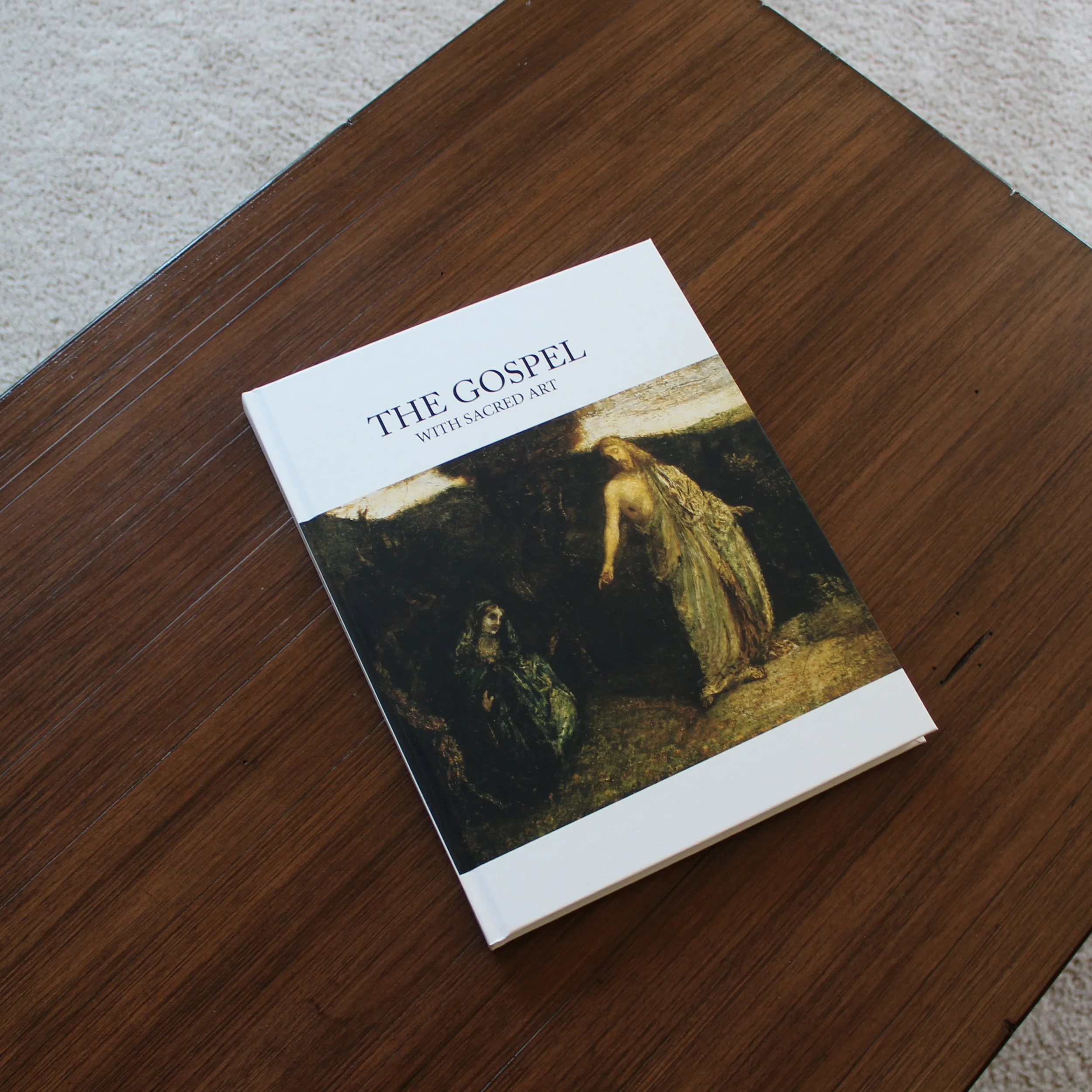 The Gospel with Sacred Art displayed on a coffee table