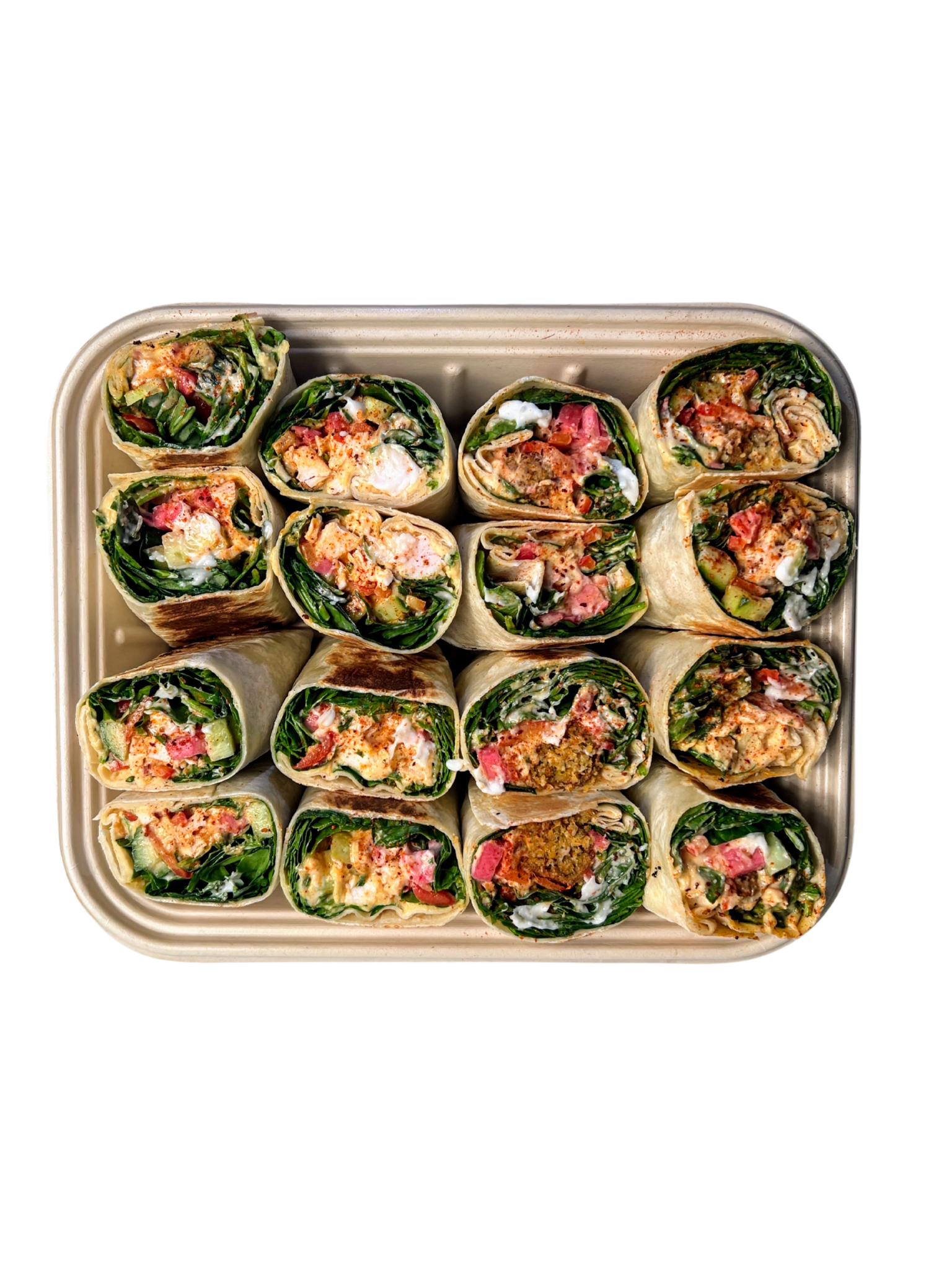 Tray with cut wraps filled with spinach, vegetables, and sauce