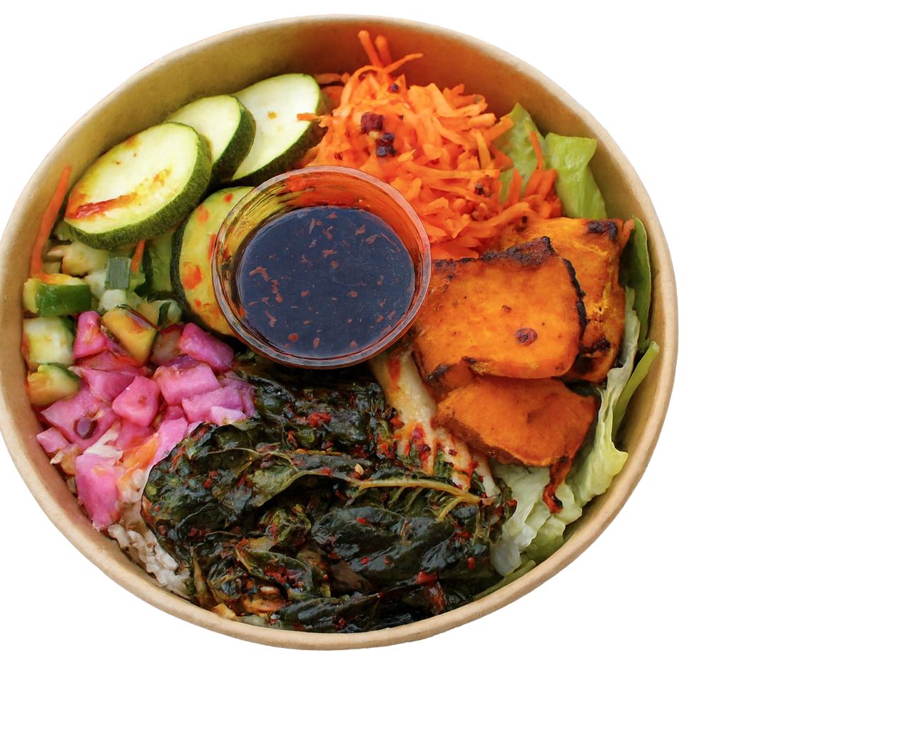 Warm bowl with broccoli, kimchi, edamame, carrots, cucumber, boiled egg, sesame seeds, and dipping sauce.