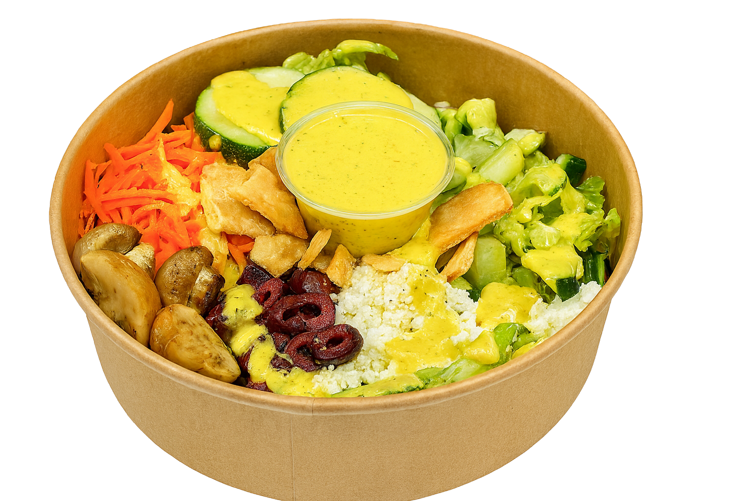 Box of salad with chickpeas, shredded carrots, sliced cucumbers, feta cheese, chopped cucumbers, red cabbage, and a small container of yellow dressing.