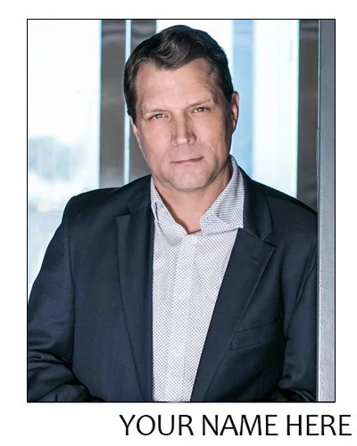 Sample image of a theatrical or business headshot of a well-groomed man wearing a navy blue blazer over a white button-down, with the caption Your Name Here below