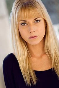 Theatrical Actor Headshot Sample featuring a blonde female wearing a dark top, moody