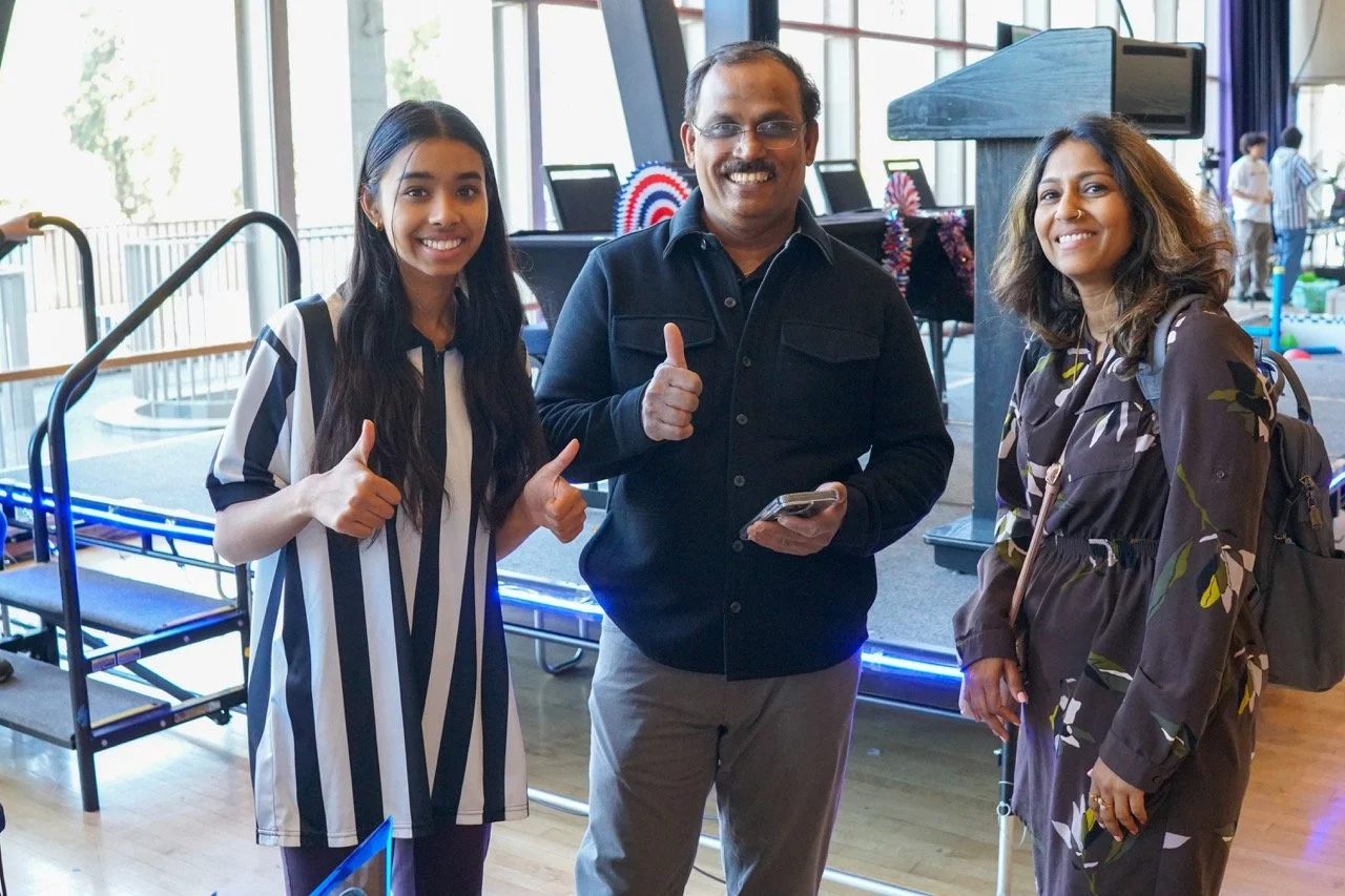 Referee and event organizer smiling and enthusiastic at a VEX Robotics signature event.