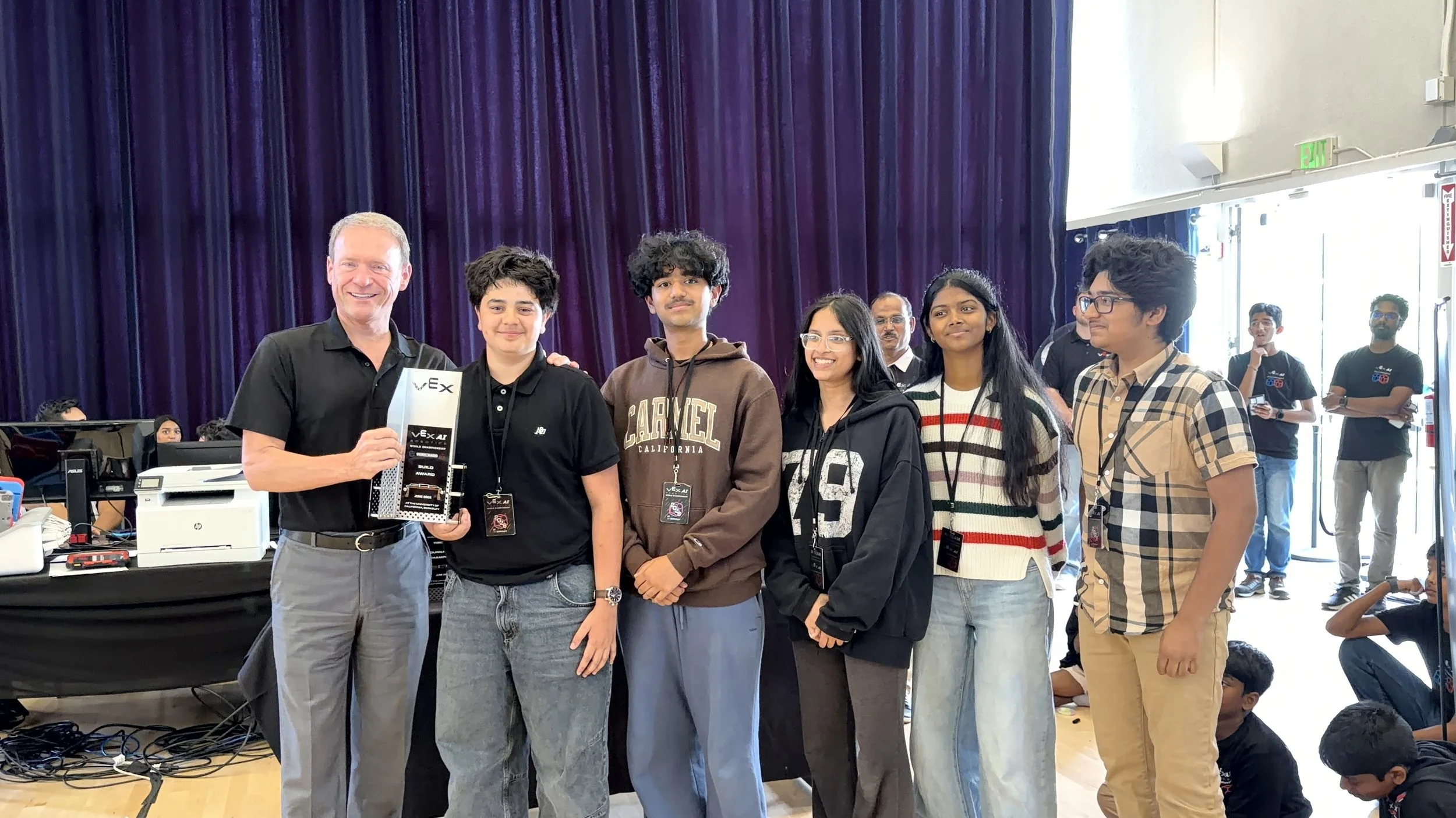 Robolabs VEX AI students celebrating an award at a VEX AI competition, showcasing their achievement in advanced robotics and artificial intelligence.