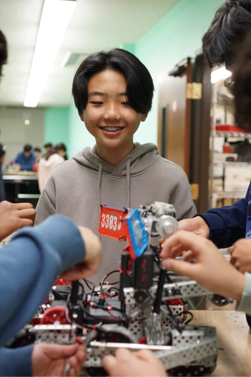 Middle school student with a VEX V5 competition robot at Robolabs