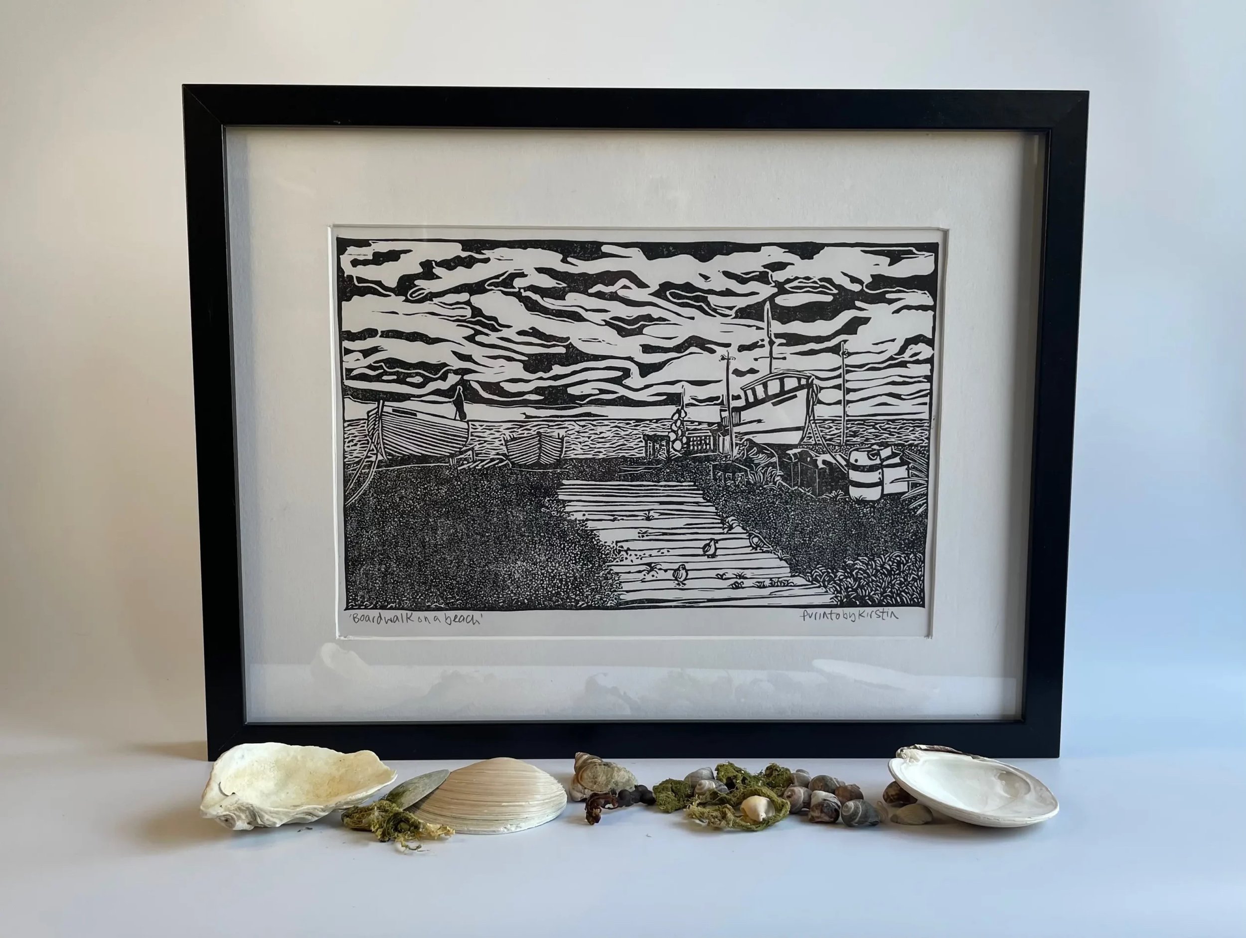 Boardwalk on a beach framed with shells.jpg