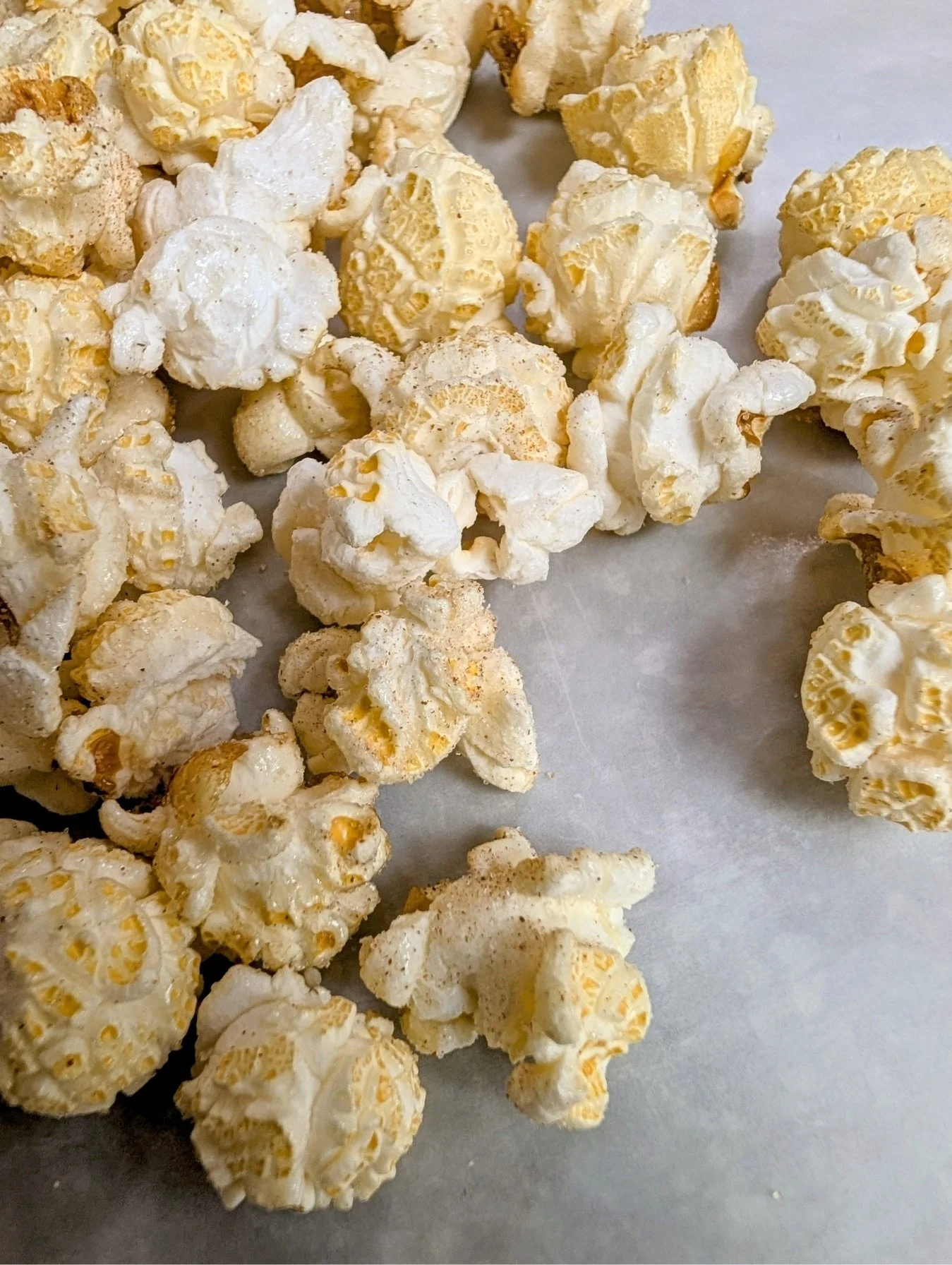 Close-up of many popped kernels of cinnamon sugar-coated kettle corn.