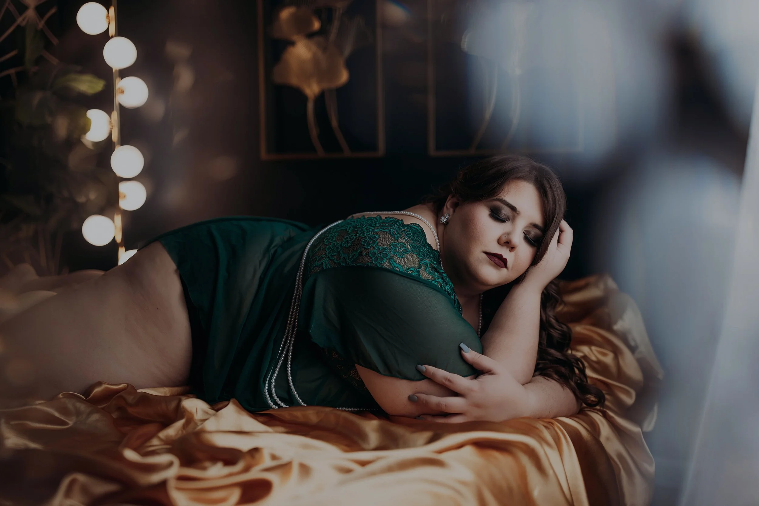 Woman in green lingerie reclining during her Hype Girl Boudoir session