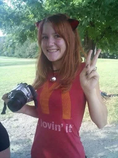 Tiffany Joyce holding a camera in 2010 during her early photography years