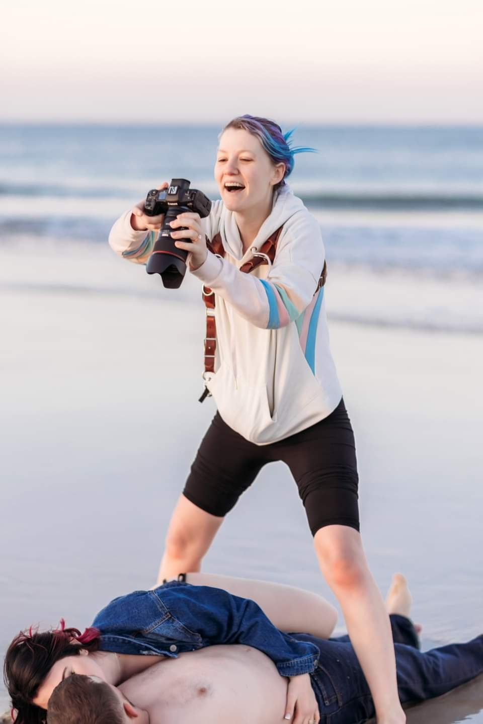 Tiffany Joyce photographing a boudoir couple during an outdoor beach session