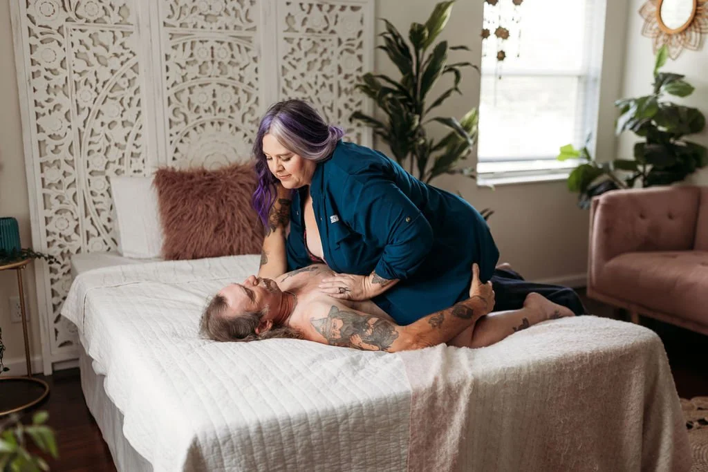 Older couple lying together on a bed during an intimate couples boudoir session