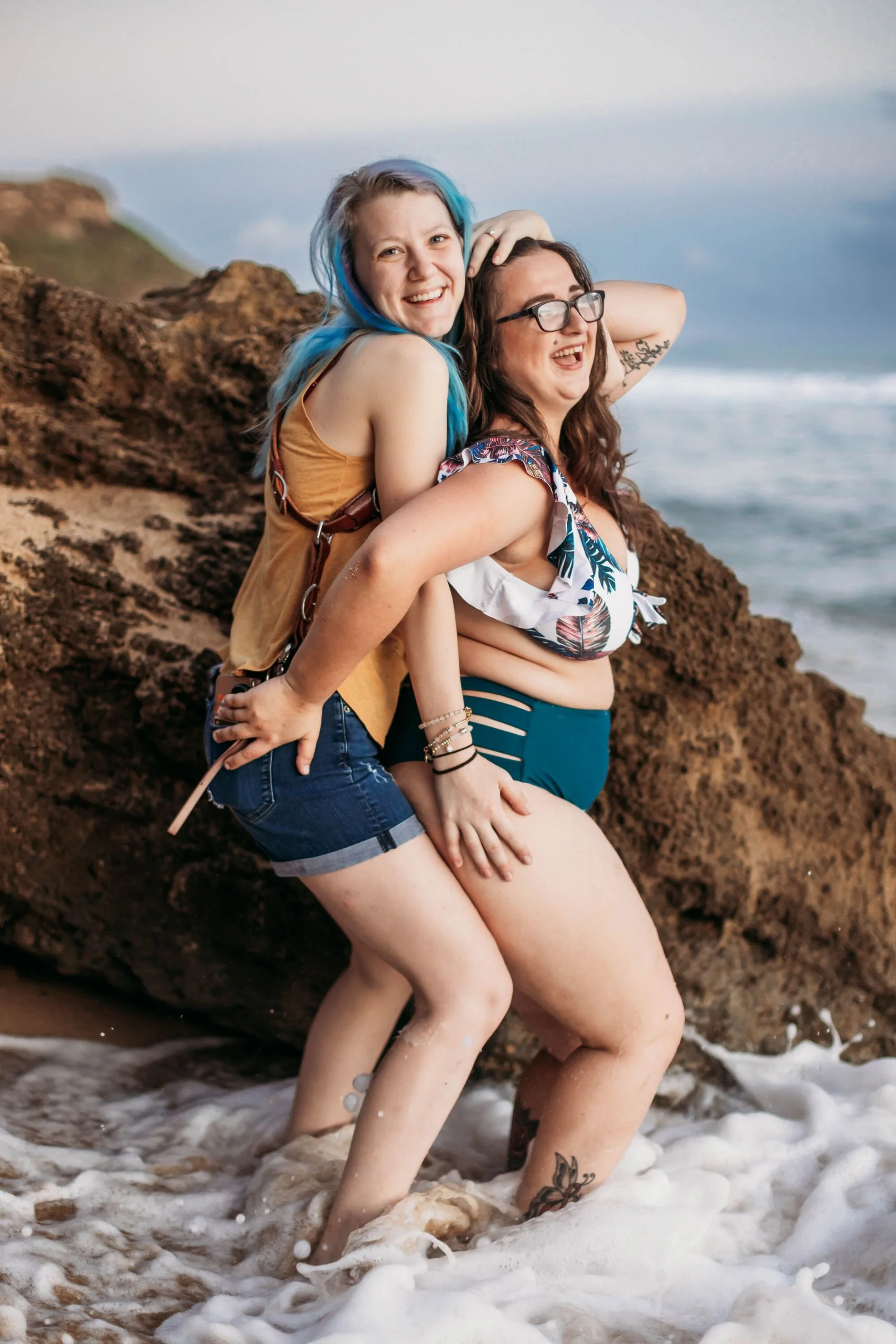 Tiffany Joyce laughing with a Hype Girl Boudoir client during an outdoor beach photography session