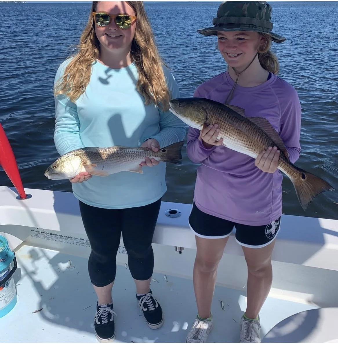 family catching redfish on fishing charter in bradenton florida near anna maria island