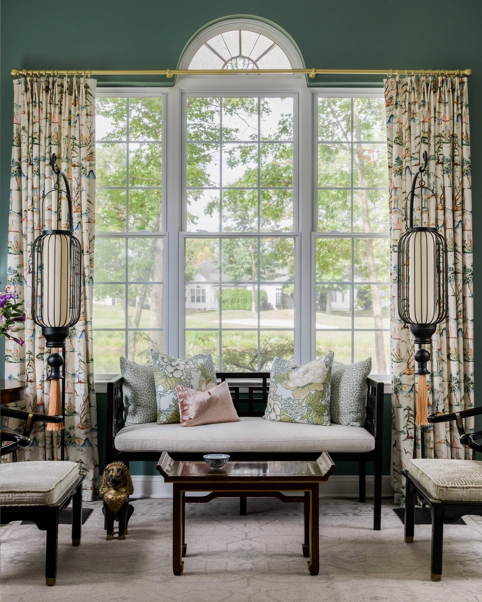 Window bench with botanical drapes and natural light in a classically styled sitting area by Juliette Sebastian Interiors.