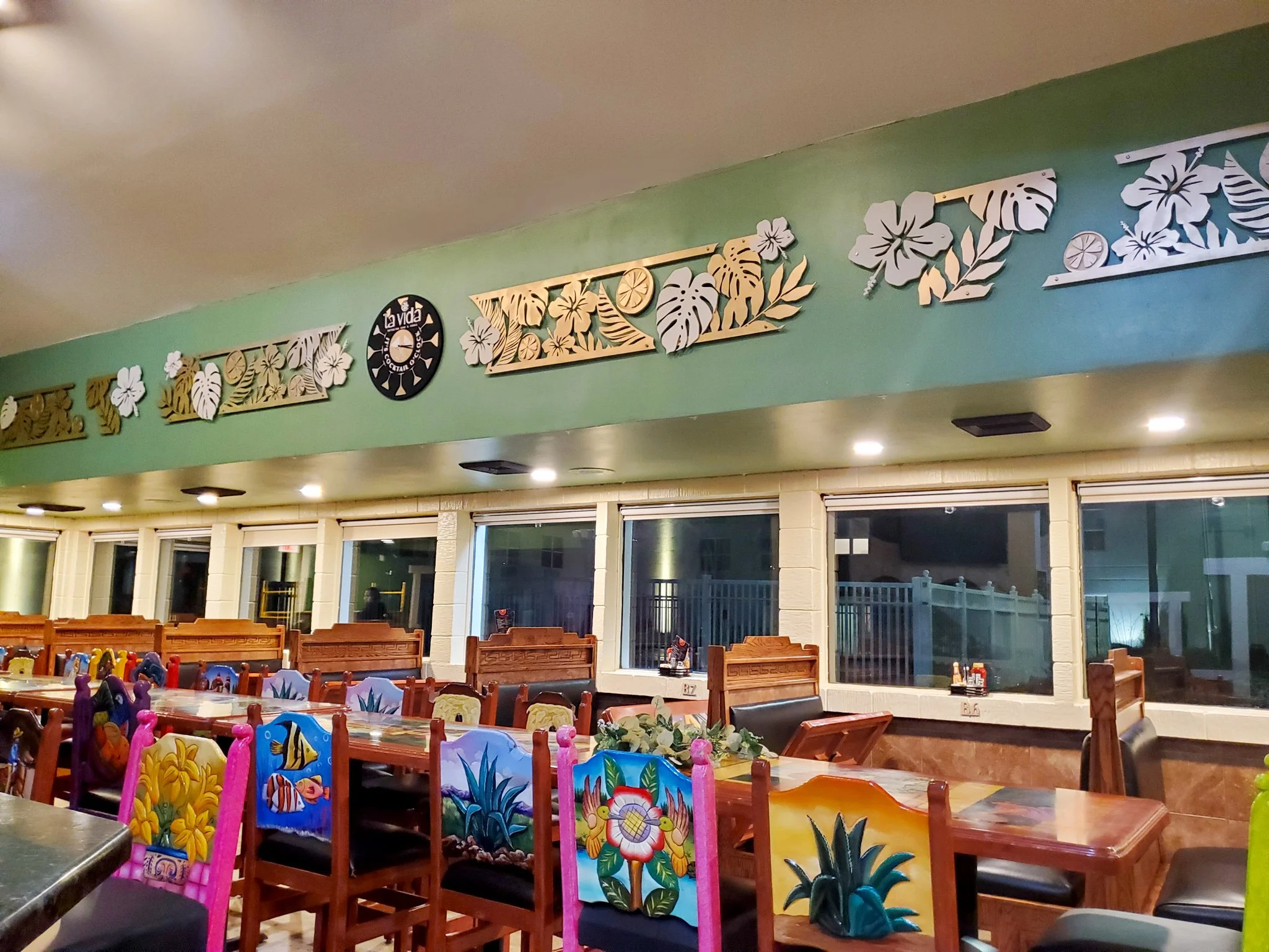 custom wooden clock, floral panels on long restaurant wall, it's cocktail o'clock, custom logo sign, floral design in a restaurant