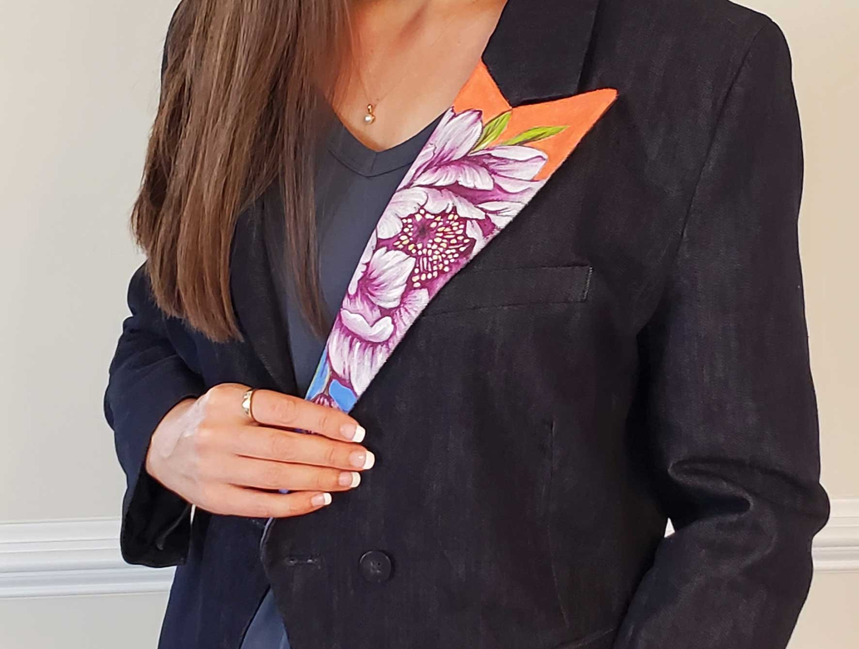 artist in hand-painted floral designer jacket
