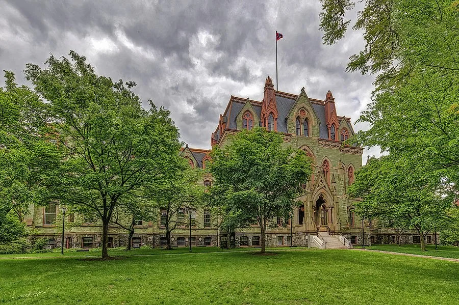 College Hall at the University of Pennsylvania campus surrounded by trees and lawn in Philadelphia