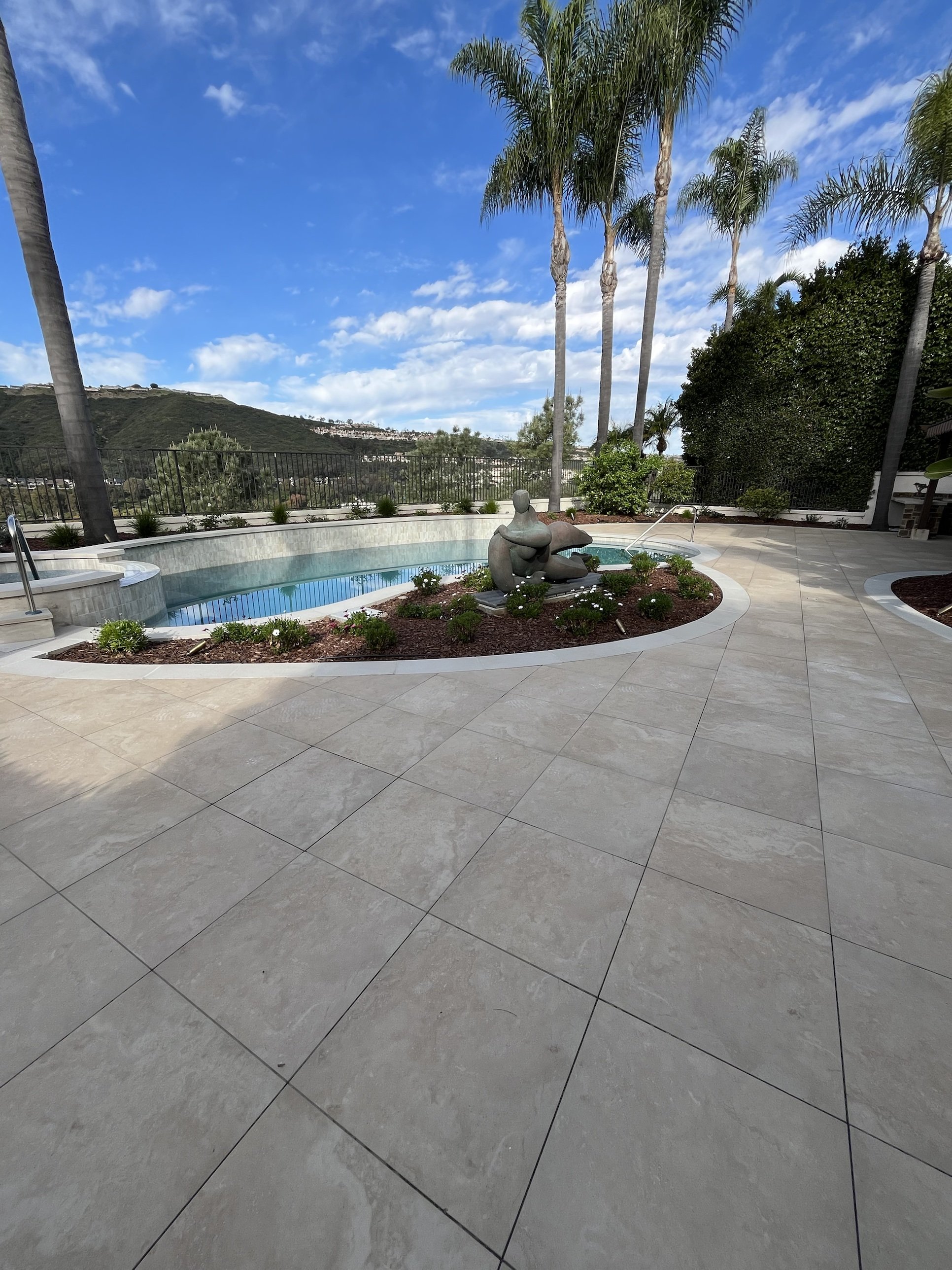 Pool Deck with Porcelain Pavers and Hillside View
