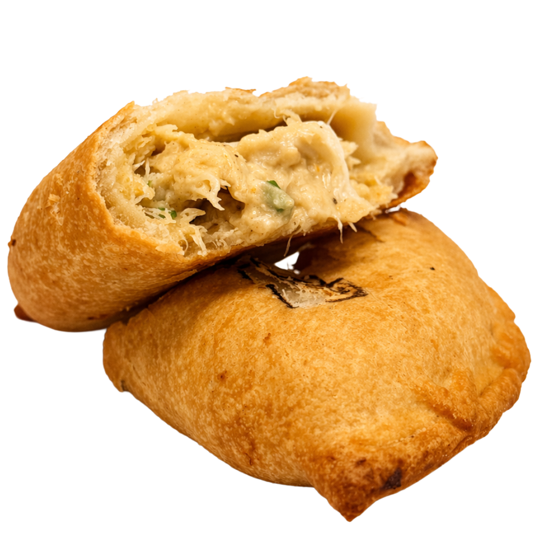 A fried pastry with a golden-brown exterior, cut open to reveal a filling of shepherds pie