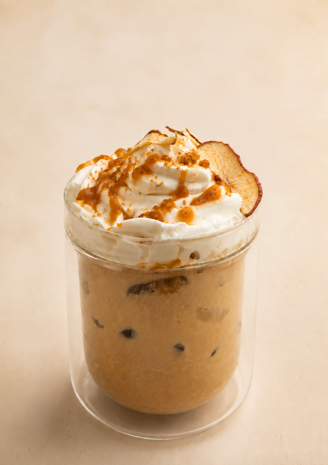 A clear glass of a creamy, APPLE BUTTER LATTE