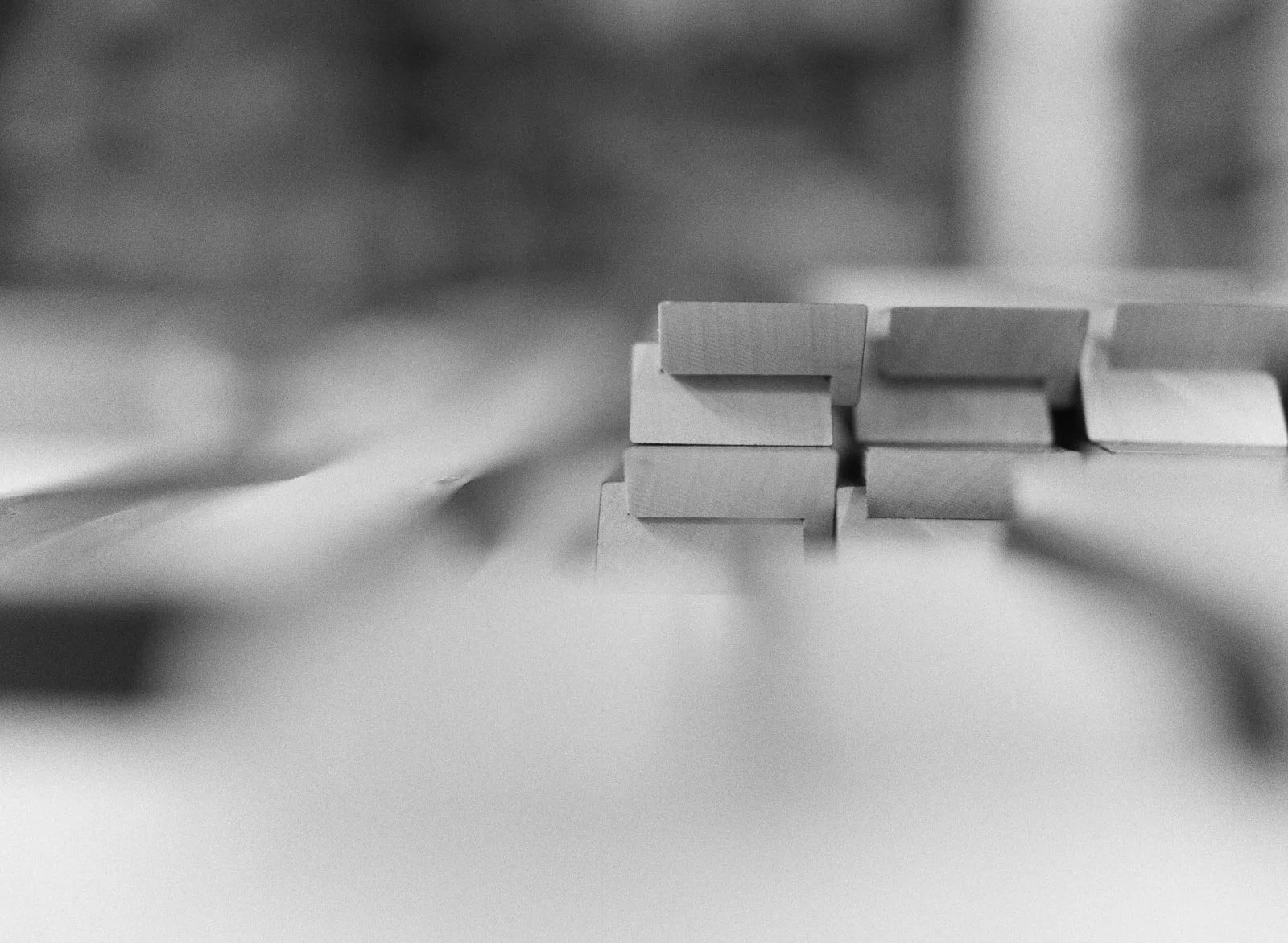 Close-up of a stack of dominoes on a table, taken in black and white.