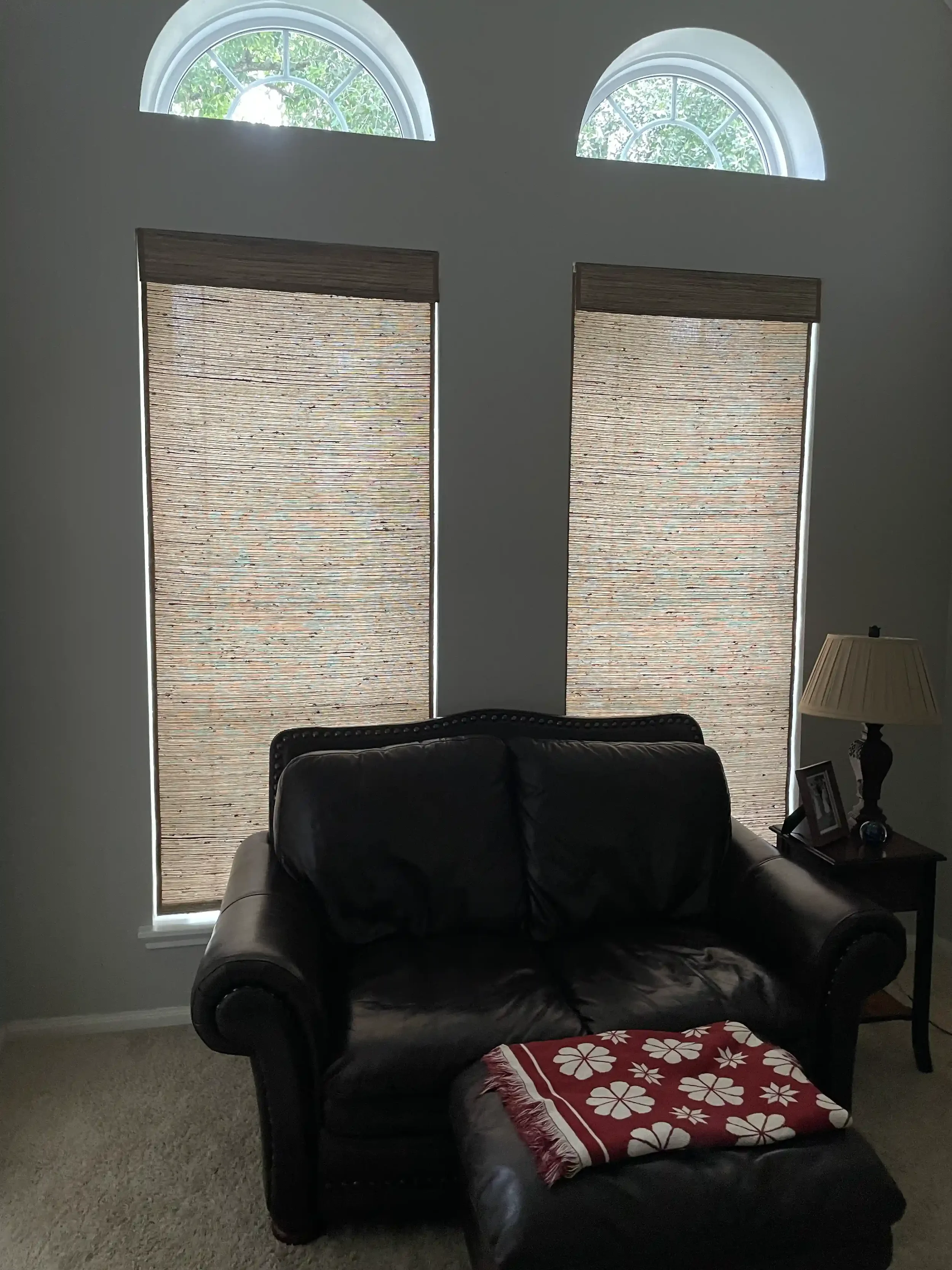 woven-wood-shades-behind-a-chair.webp